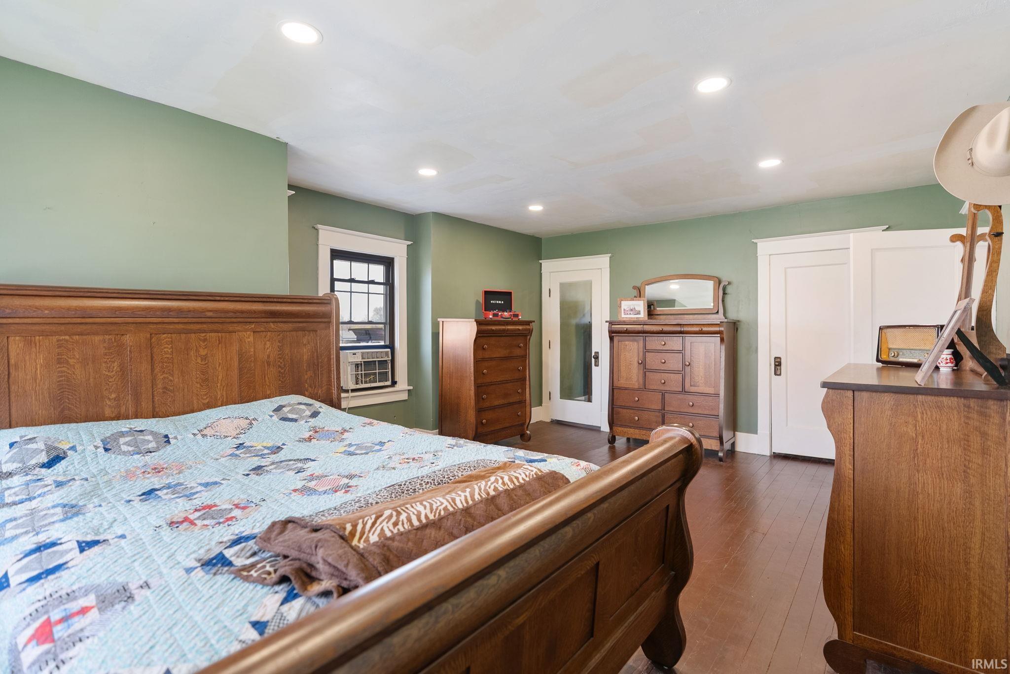 Bedroom with dark wood-type flooring and recessed lighting