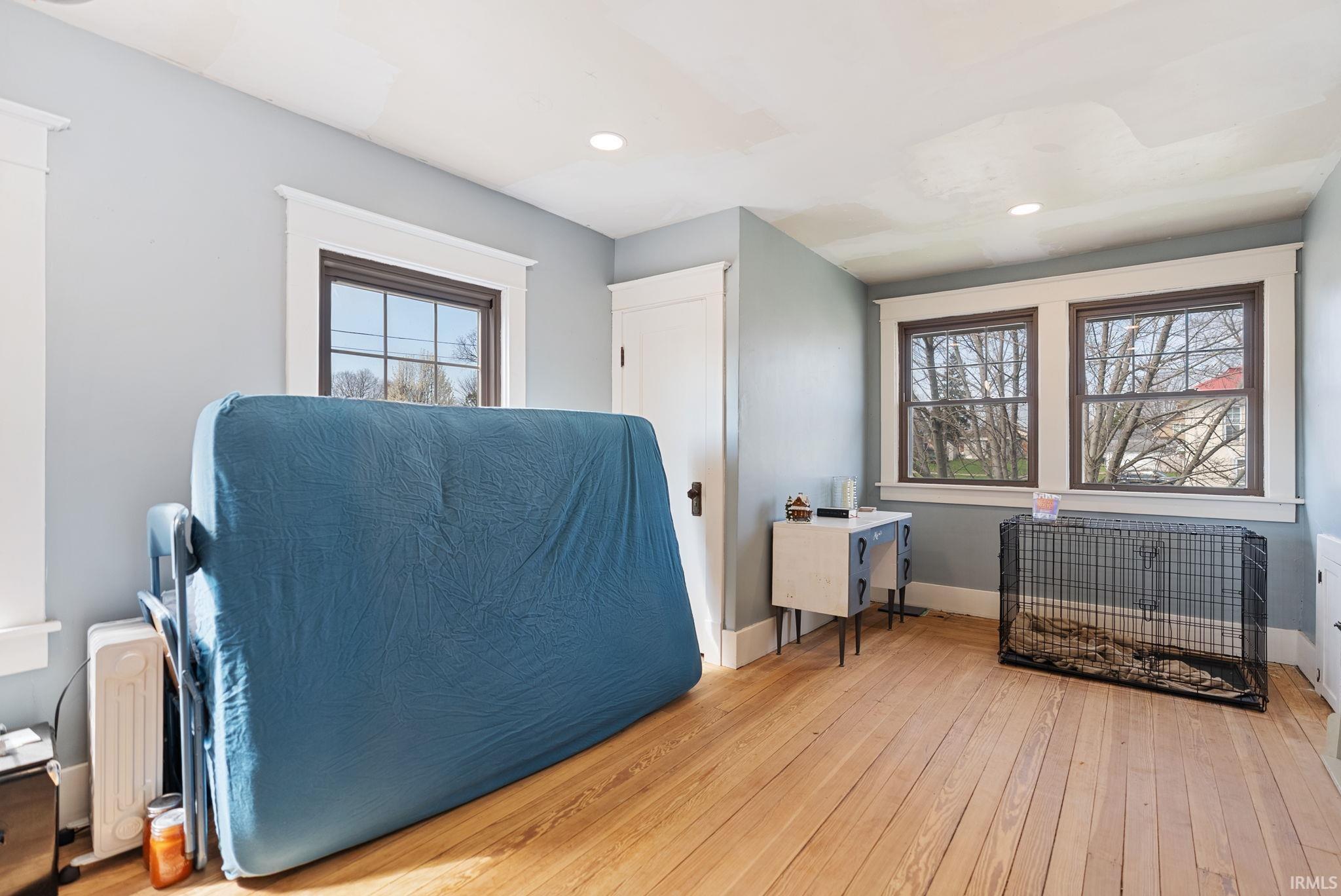 Living area with light wood-style floors, healthy amount of natural light, and recessed lighting