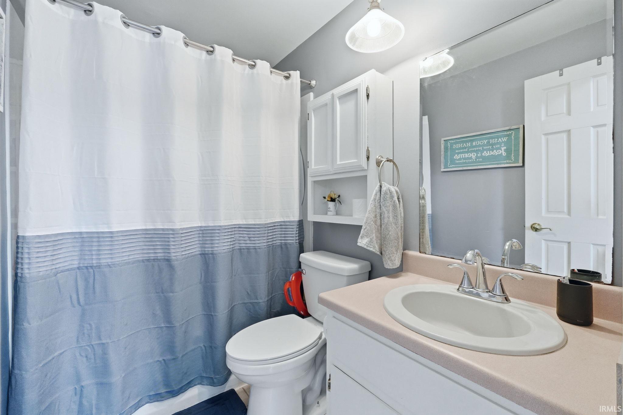 Bathroom featuring vanity and a shower with curtain