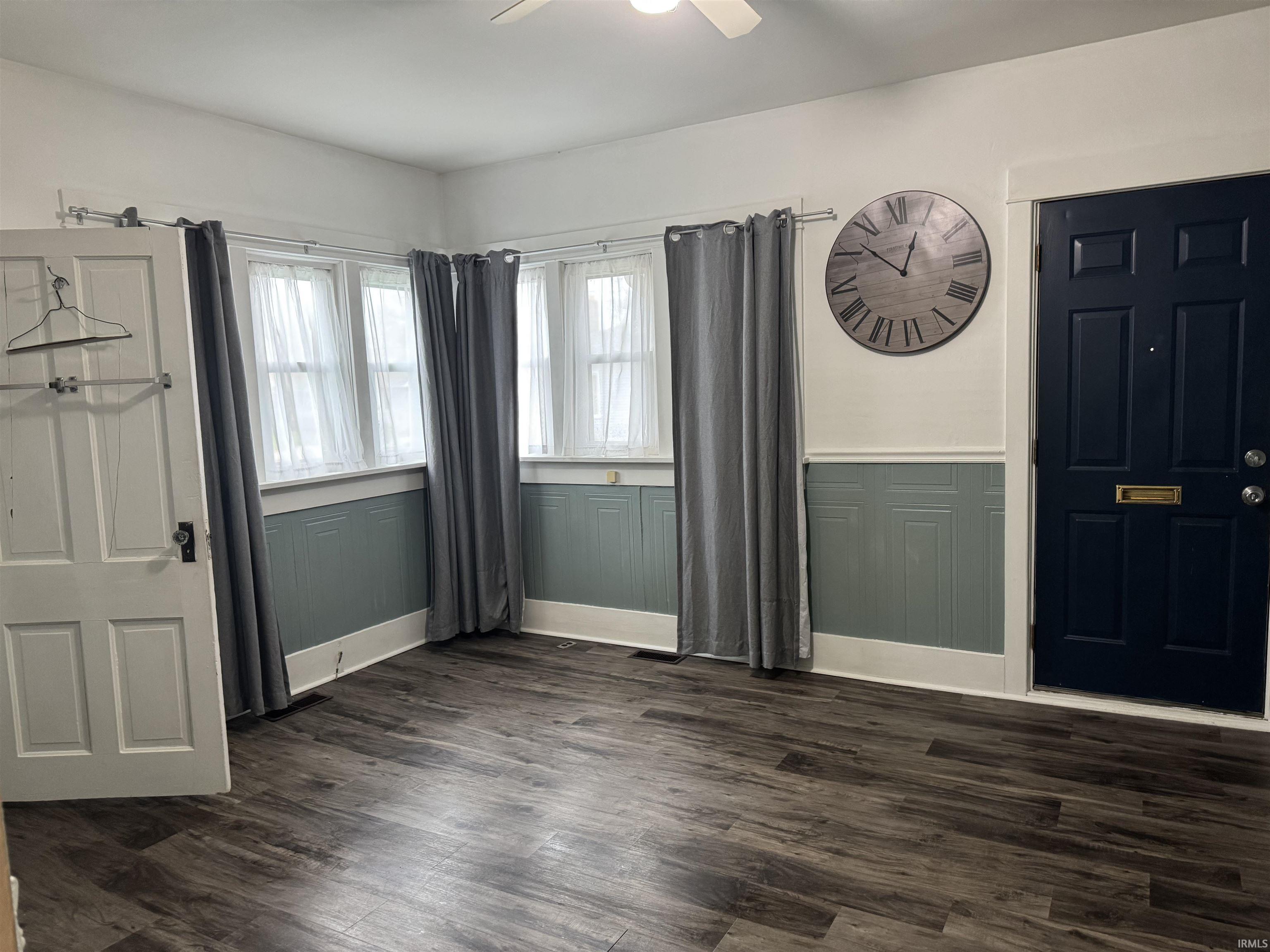 Unit 1 living room featuring, dark wood finished floors, and ceiling fan