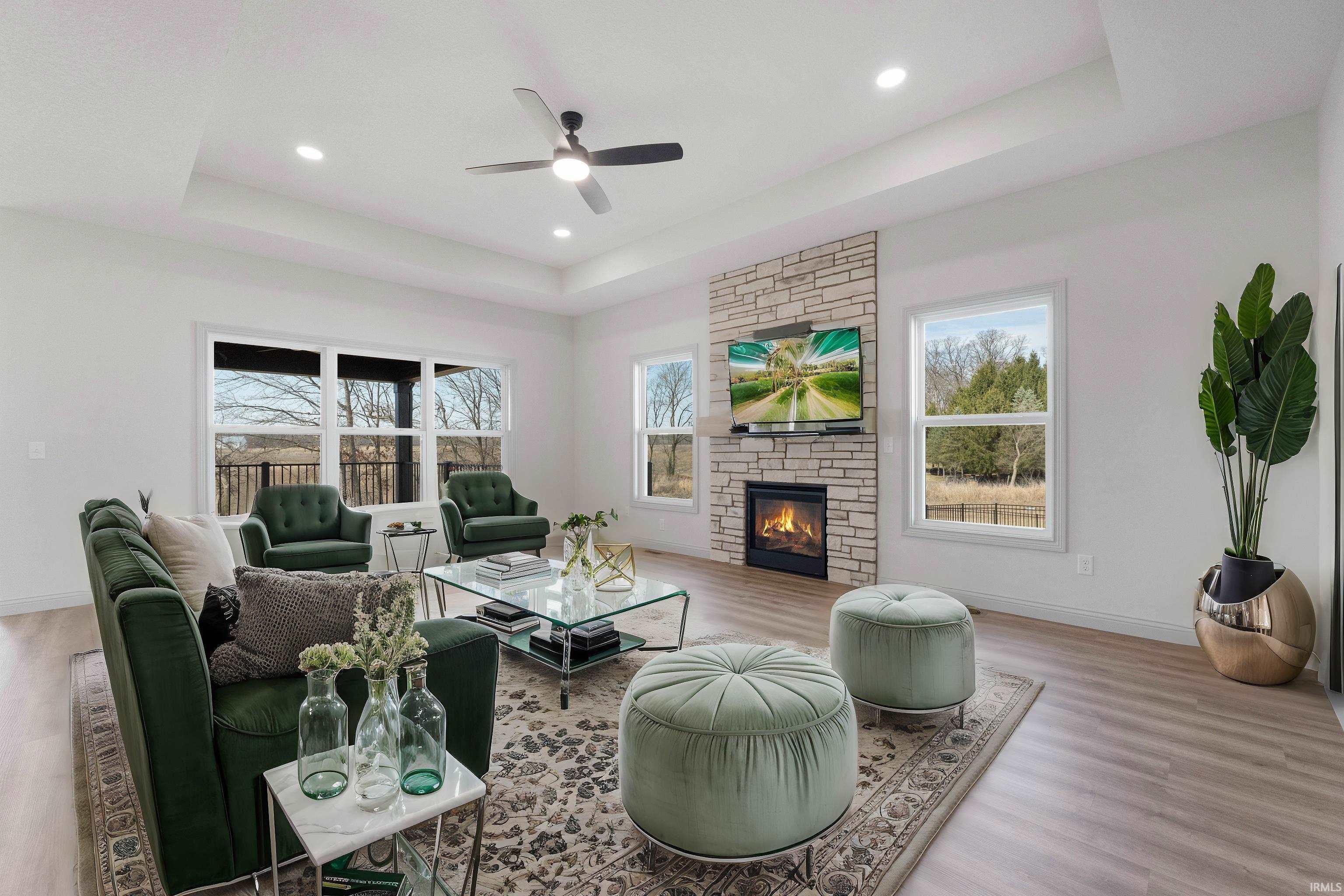 Living area featuring wood-finish flooring, a tray ceiling, and recessed lighting