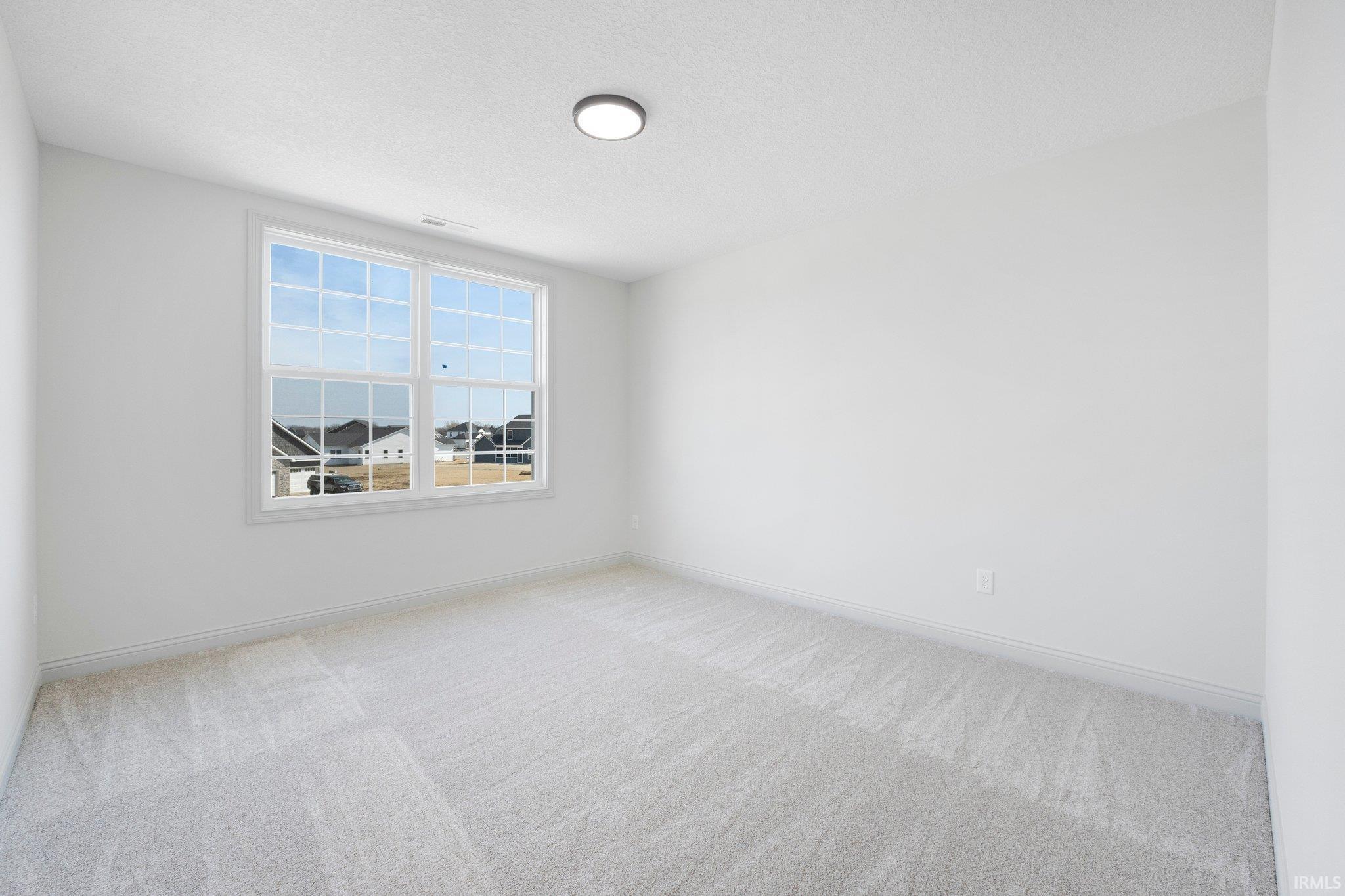 Neutral white walls complementing light gray carpeting