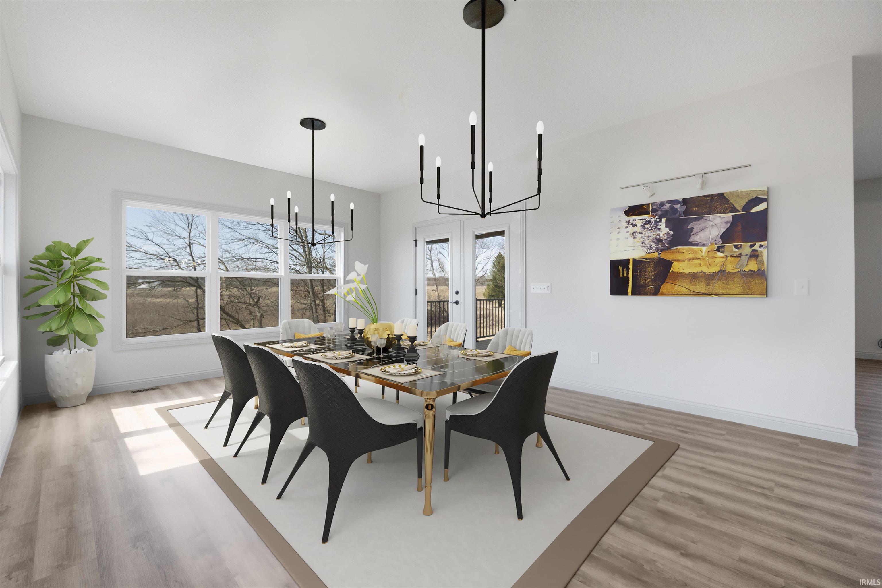 Bright dining area featuring wood-finish flooring, white walls, and a large multi-pane window