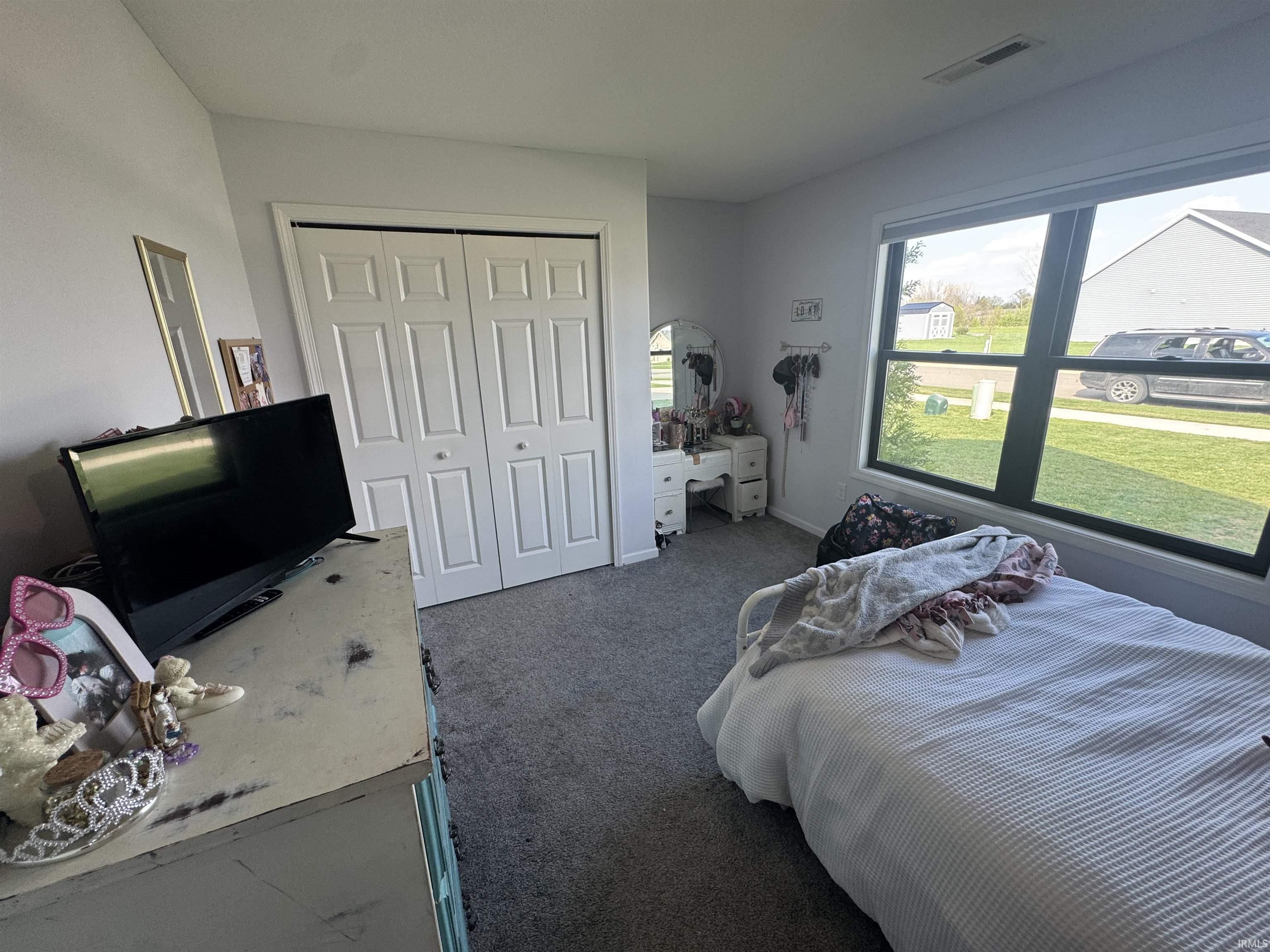 Bedroom with carpet and a closet