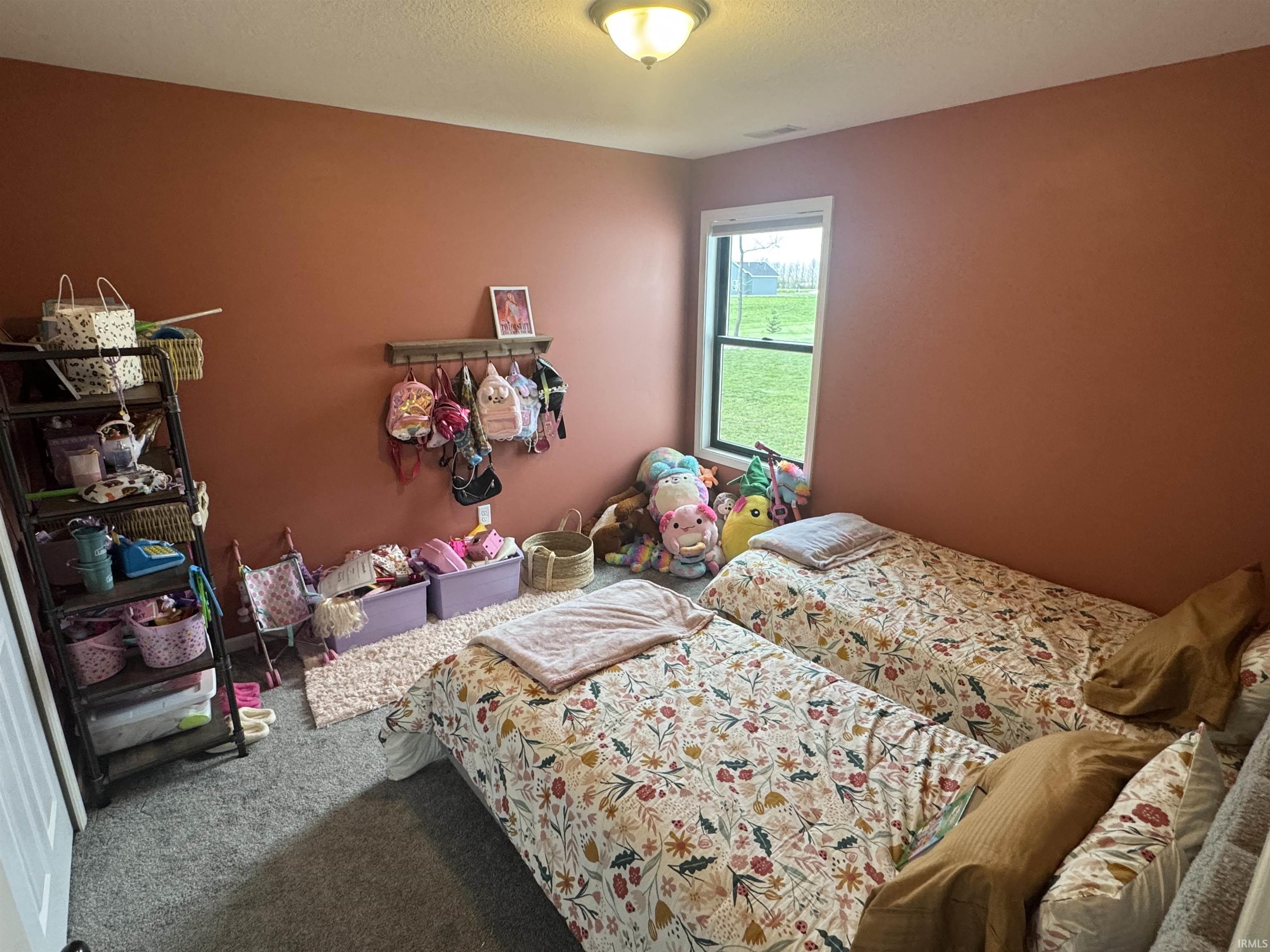 Carpeted bedroom with a textured ceiling