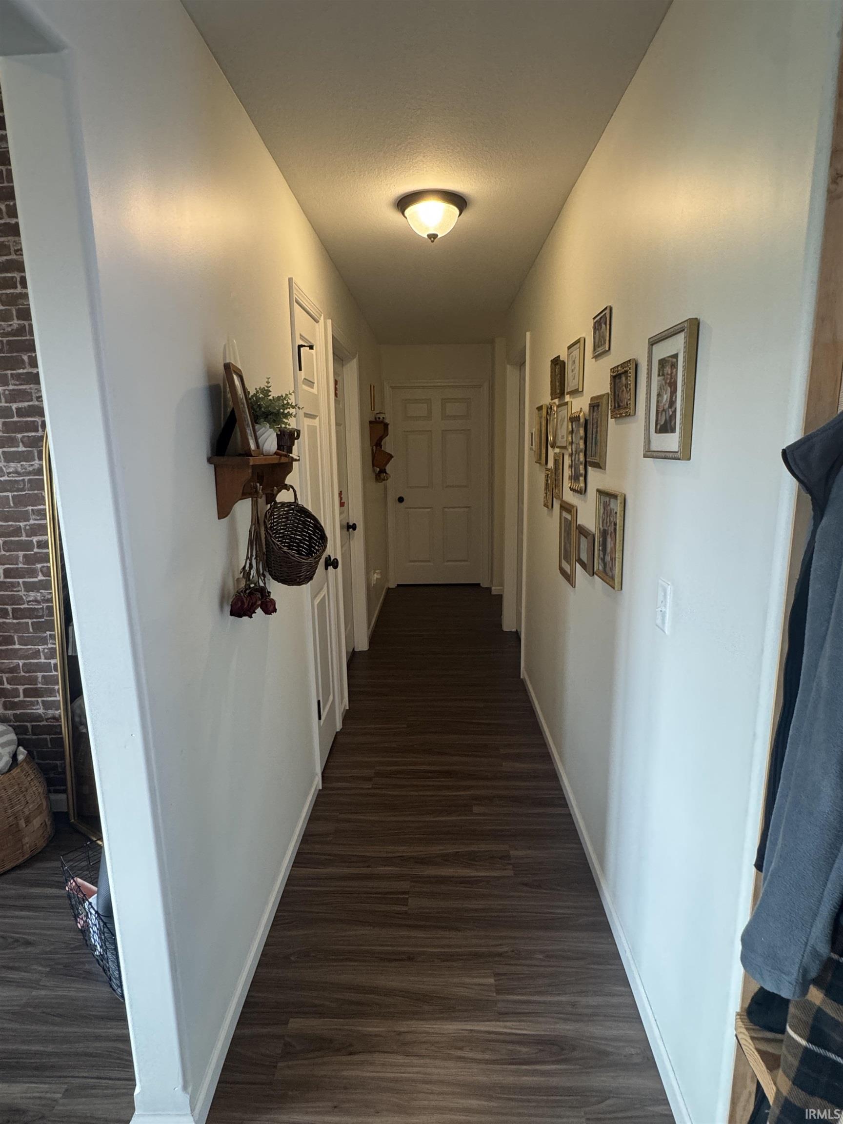Hall featuring dark wood-type flooring