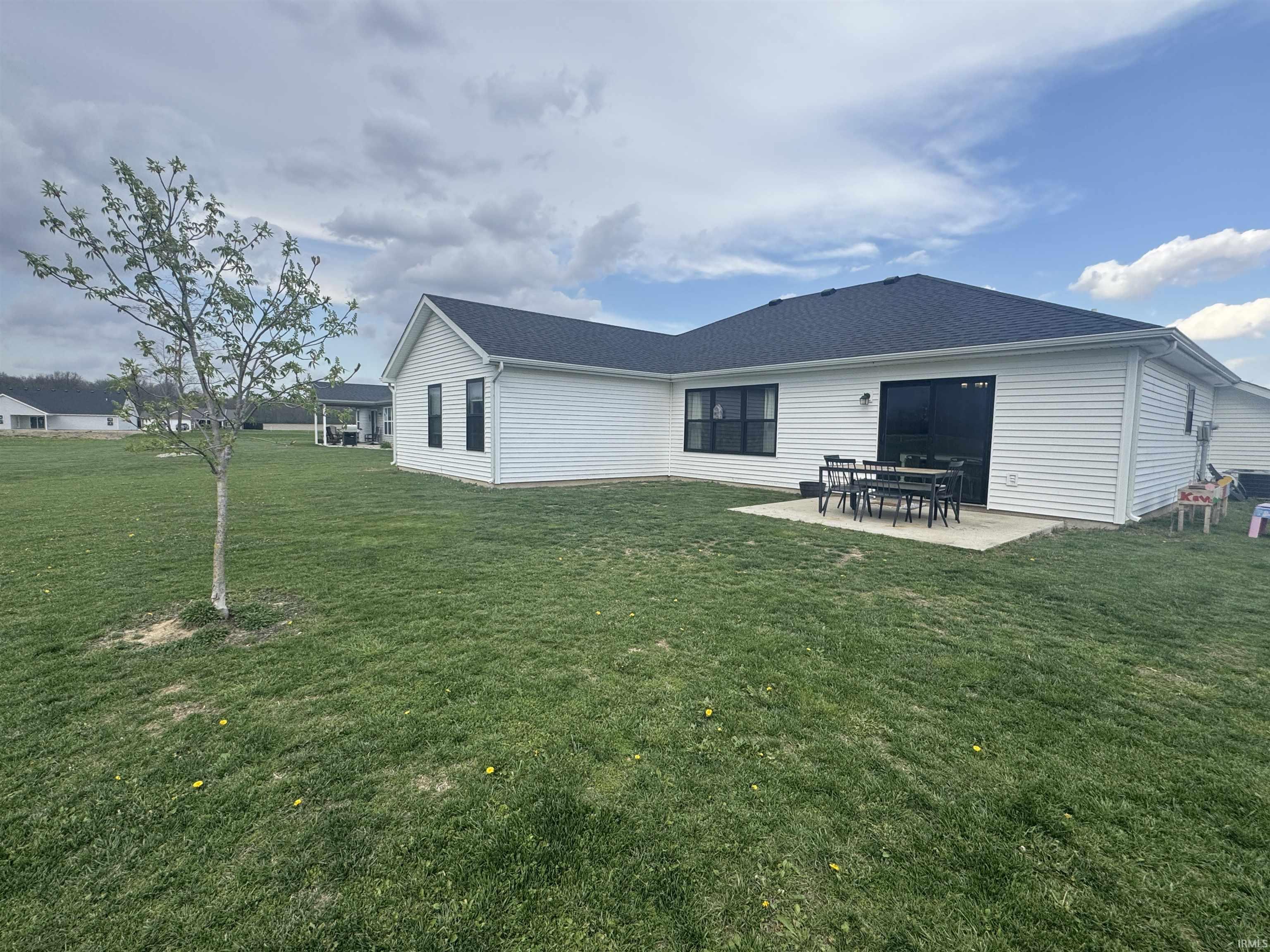 Rear view of house featuring a patio area and a yard