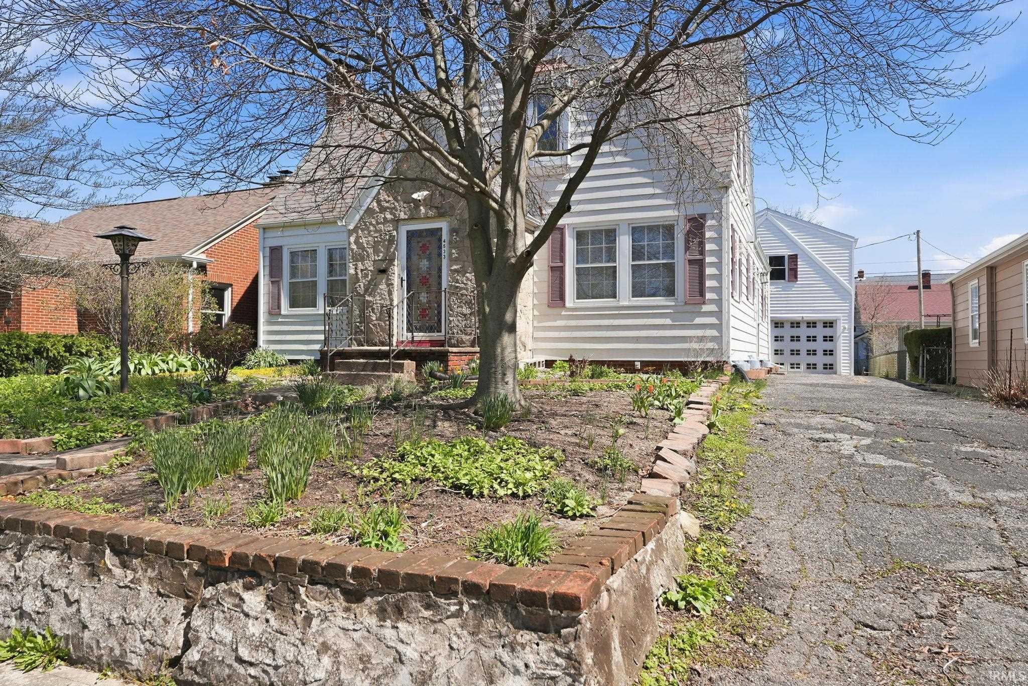 View of front facade featuring asphalt driveway