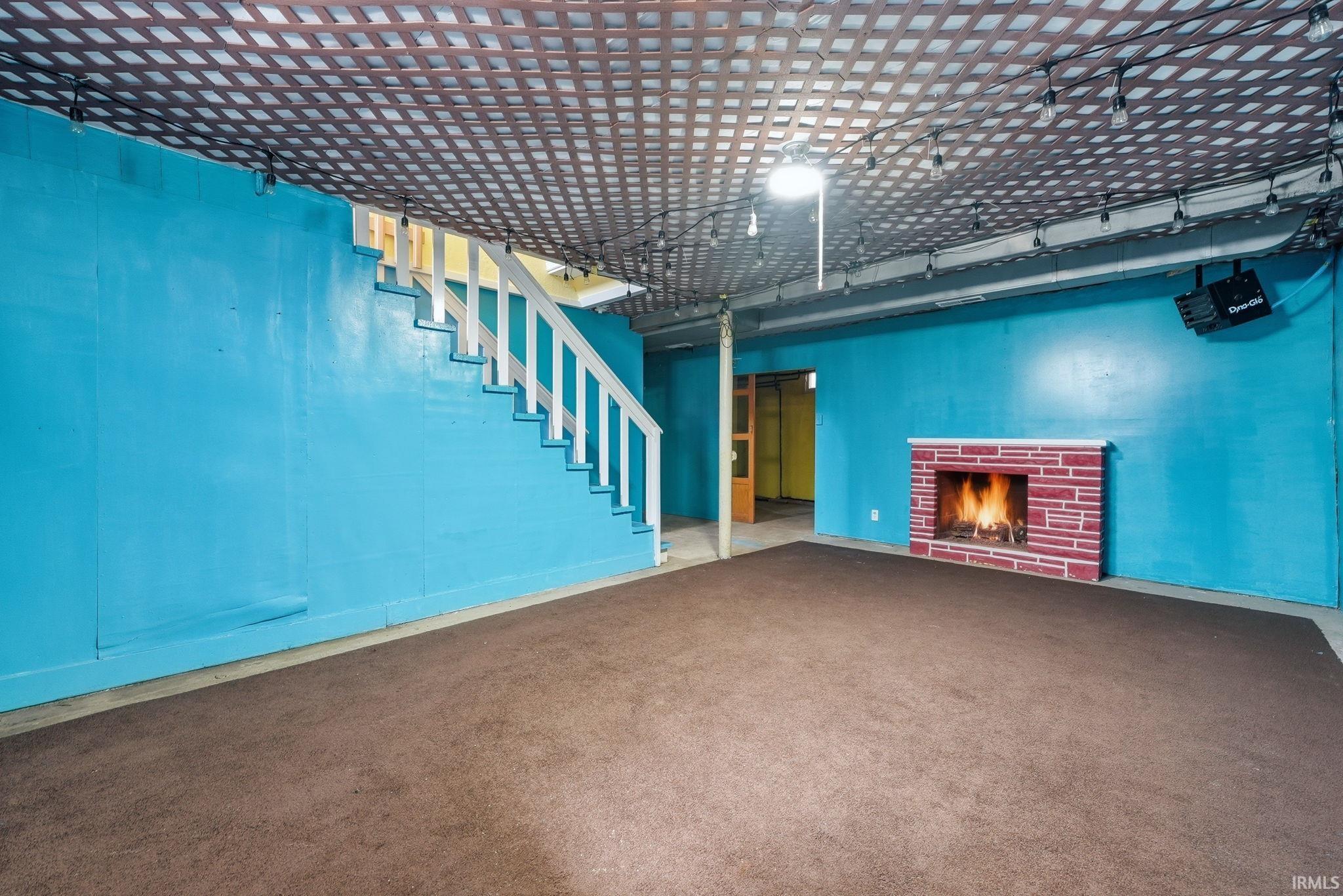 Finished below grade area featuring a fireplace and carpet floors