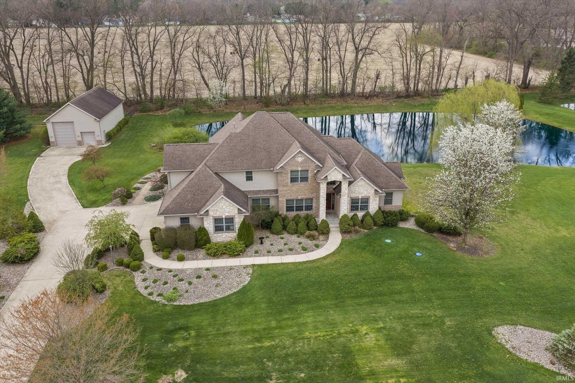Aerial view of property and surrounding area featuring a nearby body of water