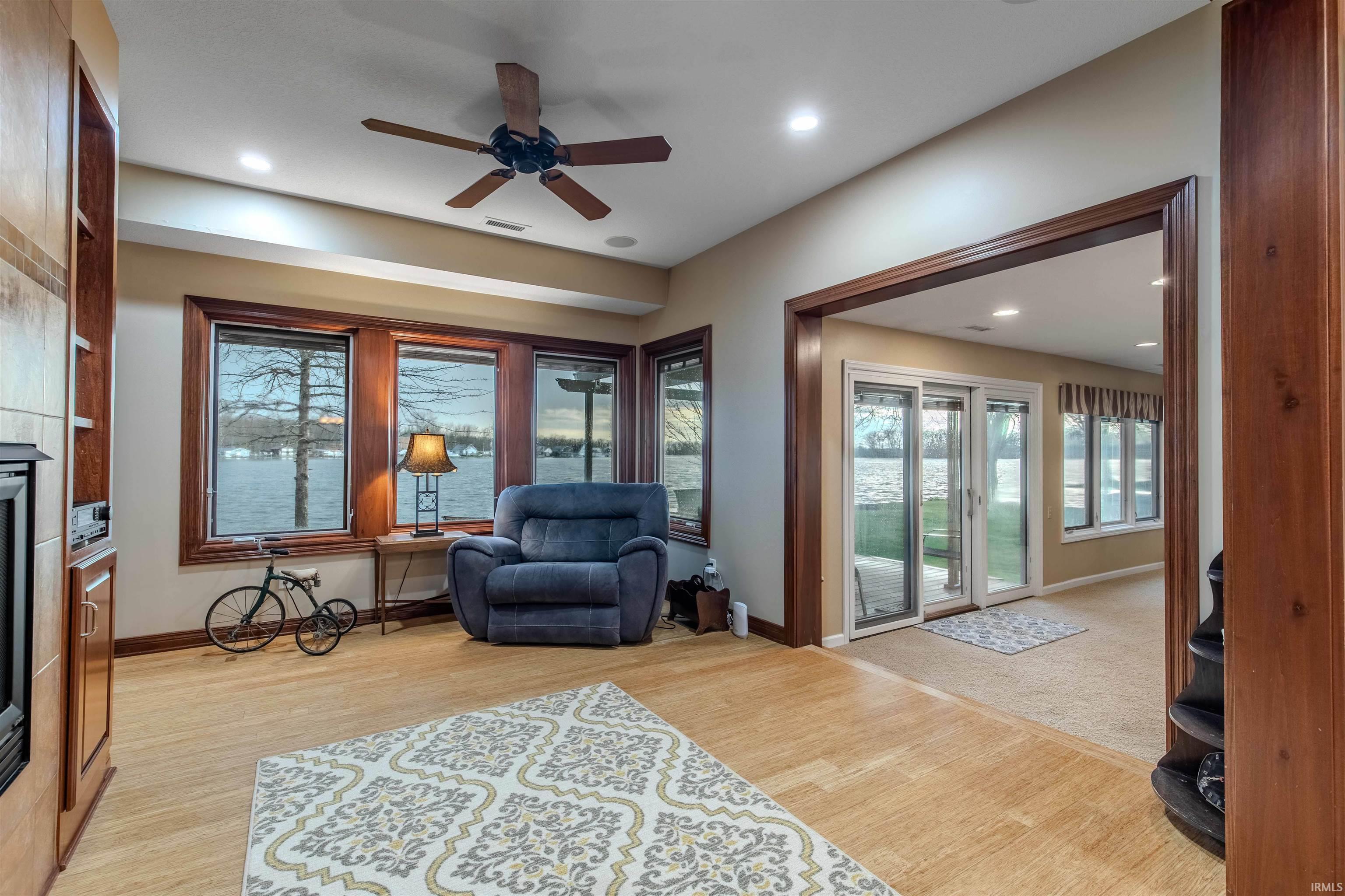 Sitting room with Bamboo flooring, and recessed lighting to warm up around the cozy fireplace.