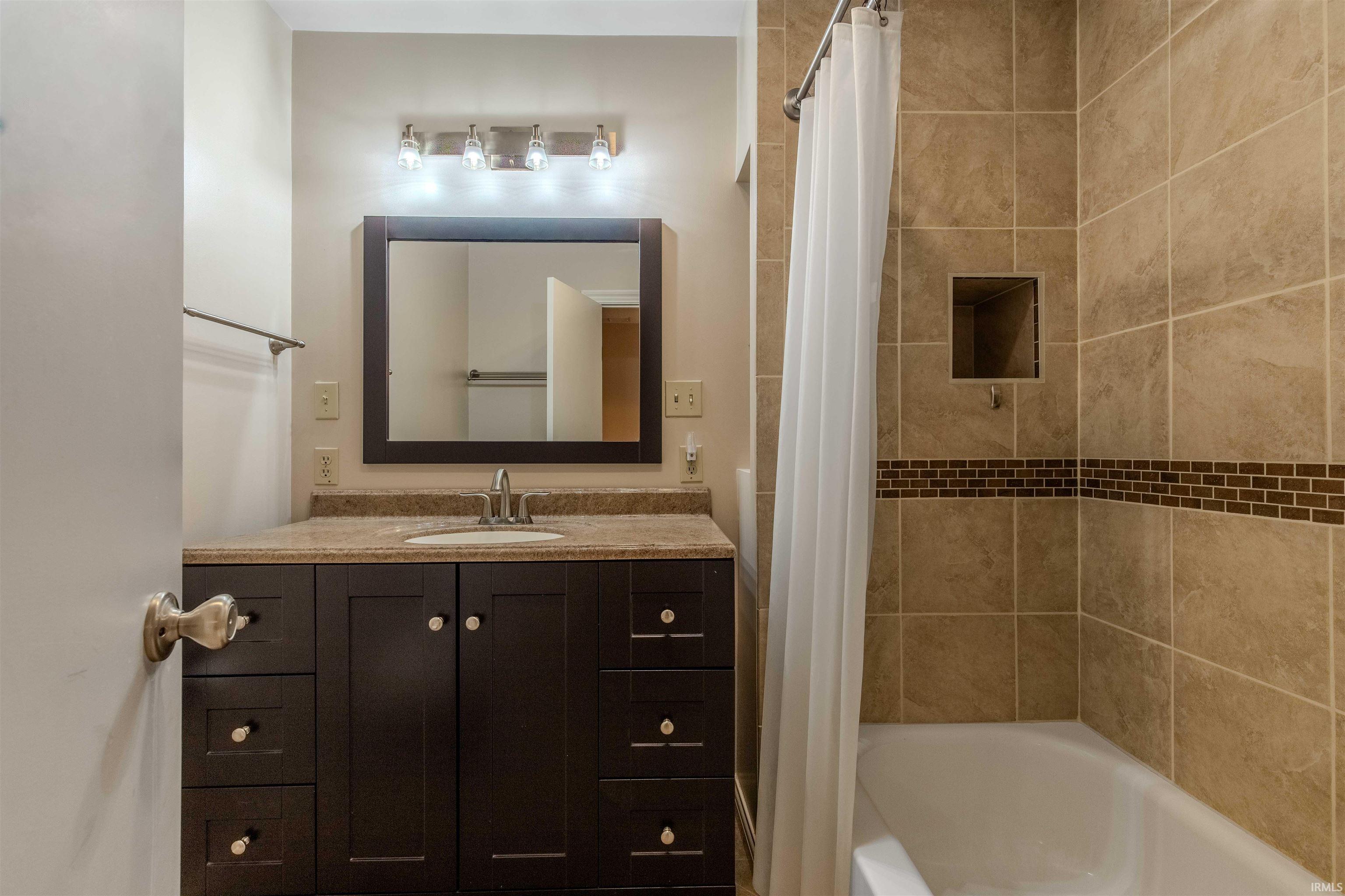 2nd Full Bathroom with vanity and custom tile shower / bathtub combination.