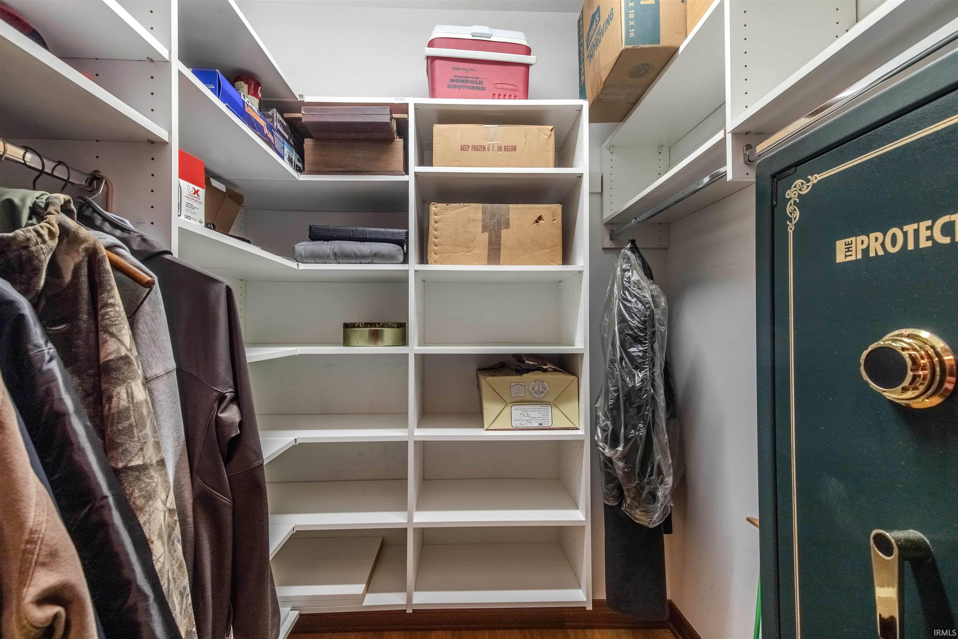 Walk in closet featuring dark wood-type flooring