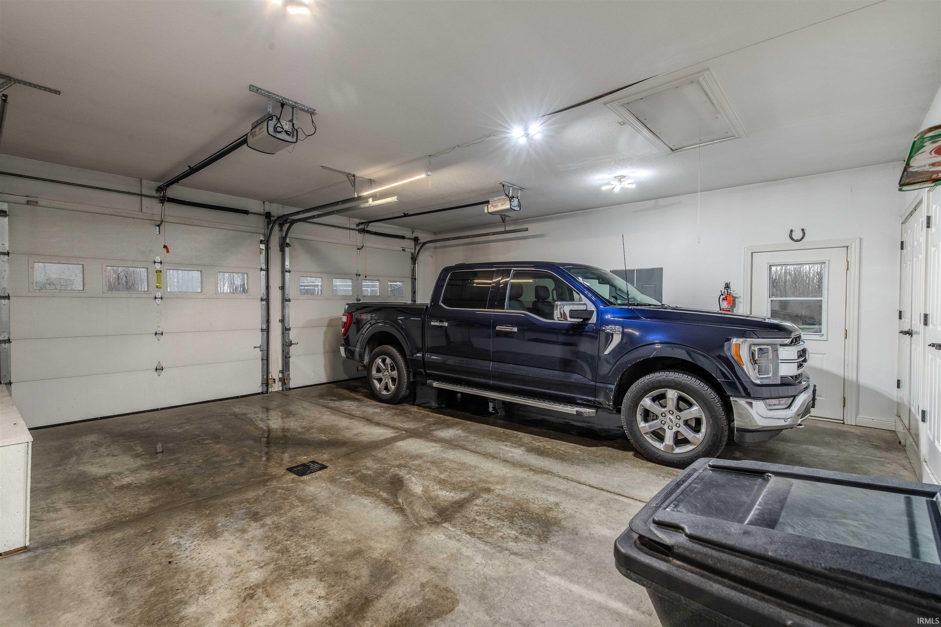Attached 2 Car Garage portion, finished & in floor drains.