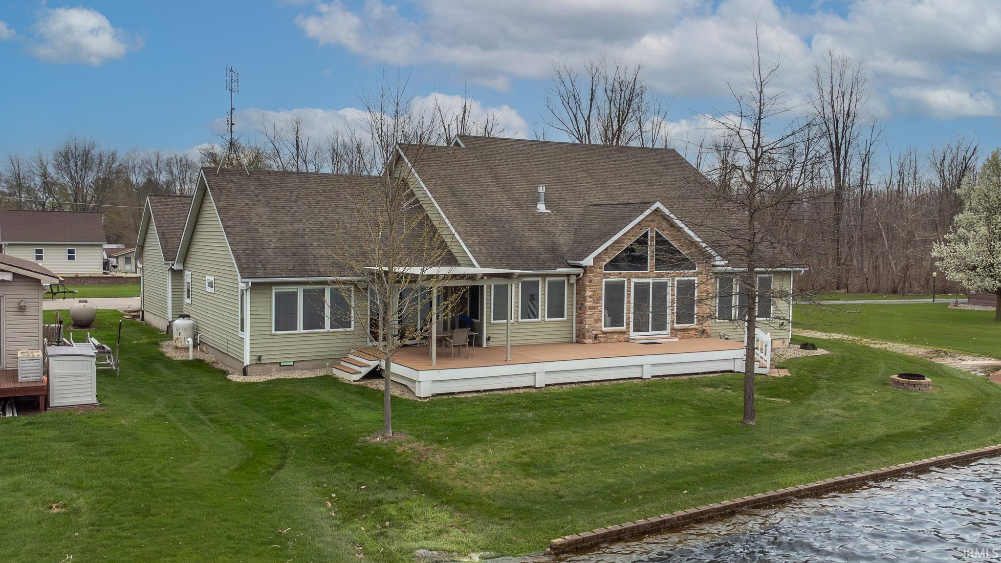 Rear view of house featuring a the large custom patio w/custom pergola, and patio furniture.