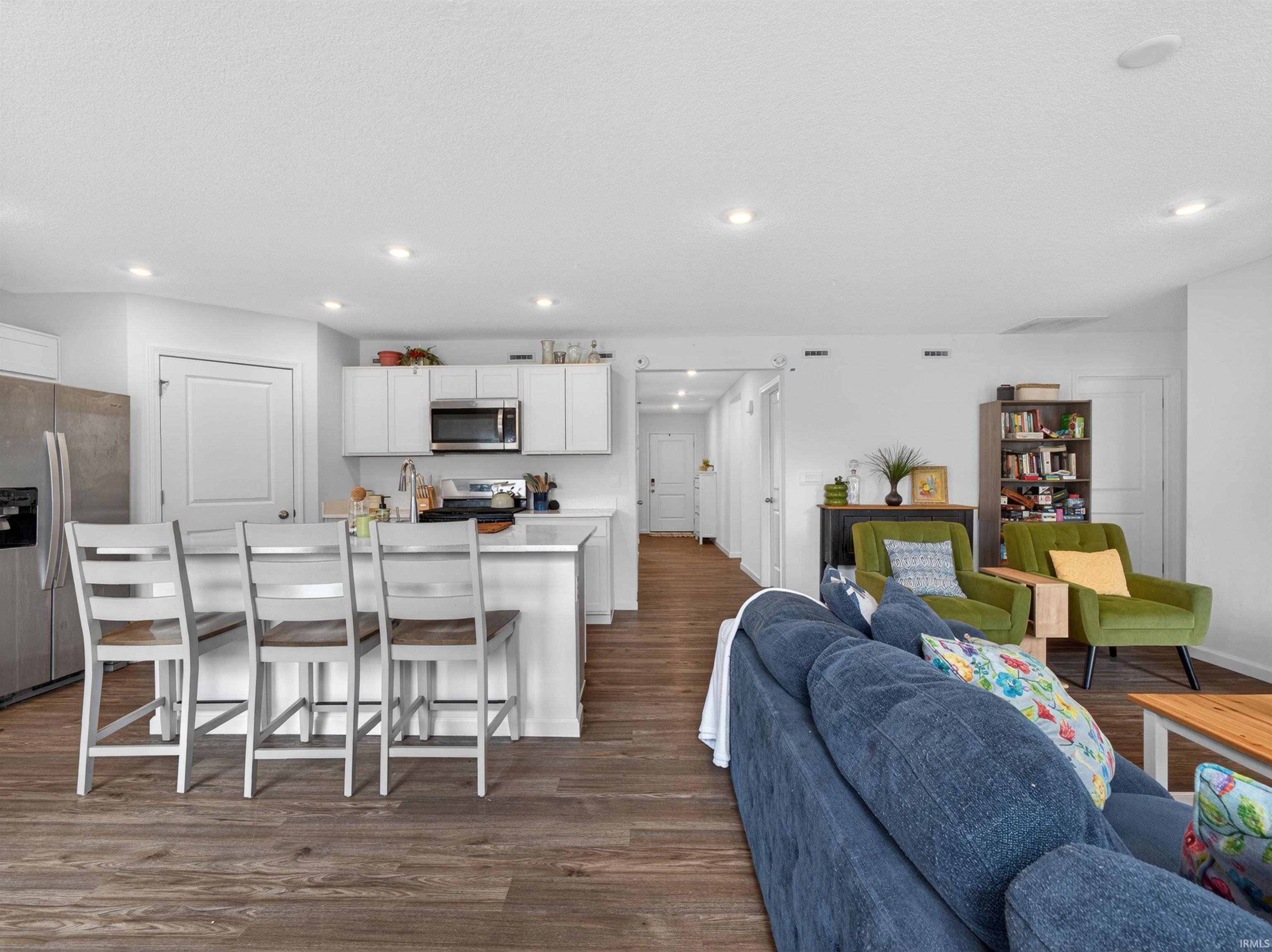 Living room featuring dark wood finished floors and recessed lighting