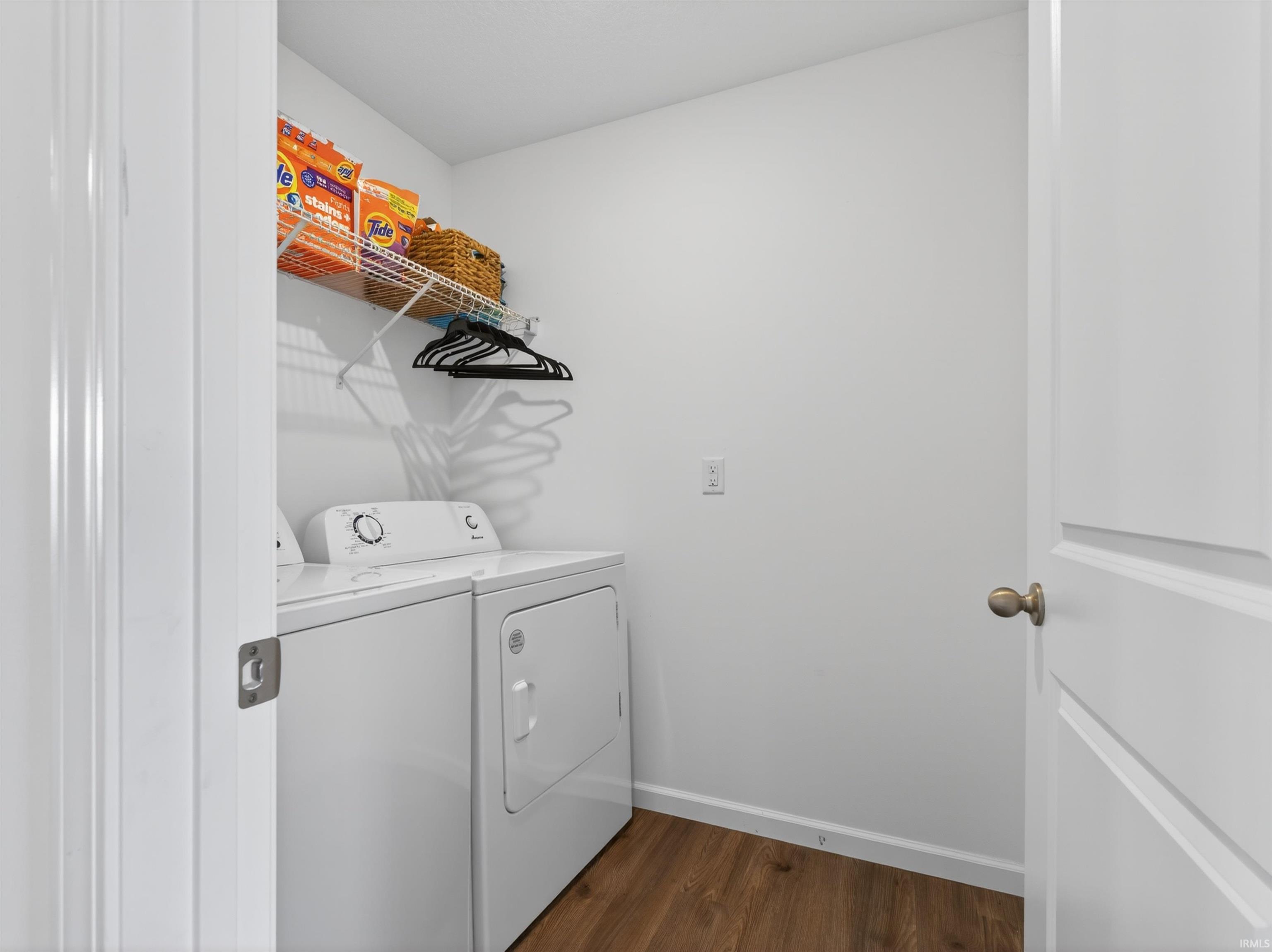 Laundry area featuring dark wood-style floors and separate washer and dryer
