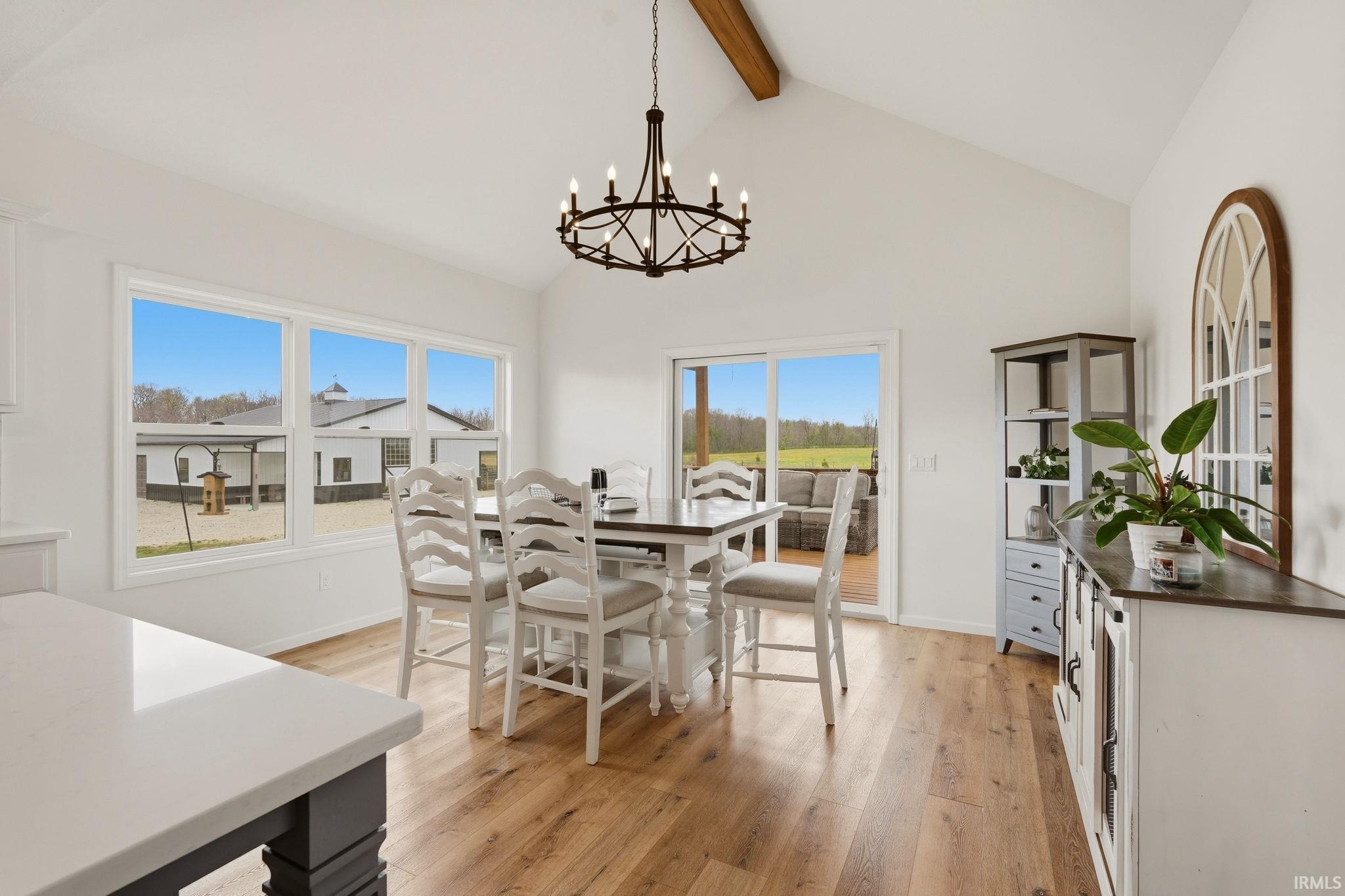 Dining space with light wood-style flooring and a chandelier