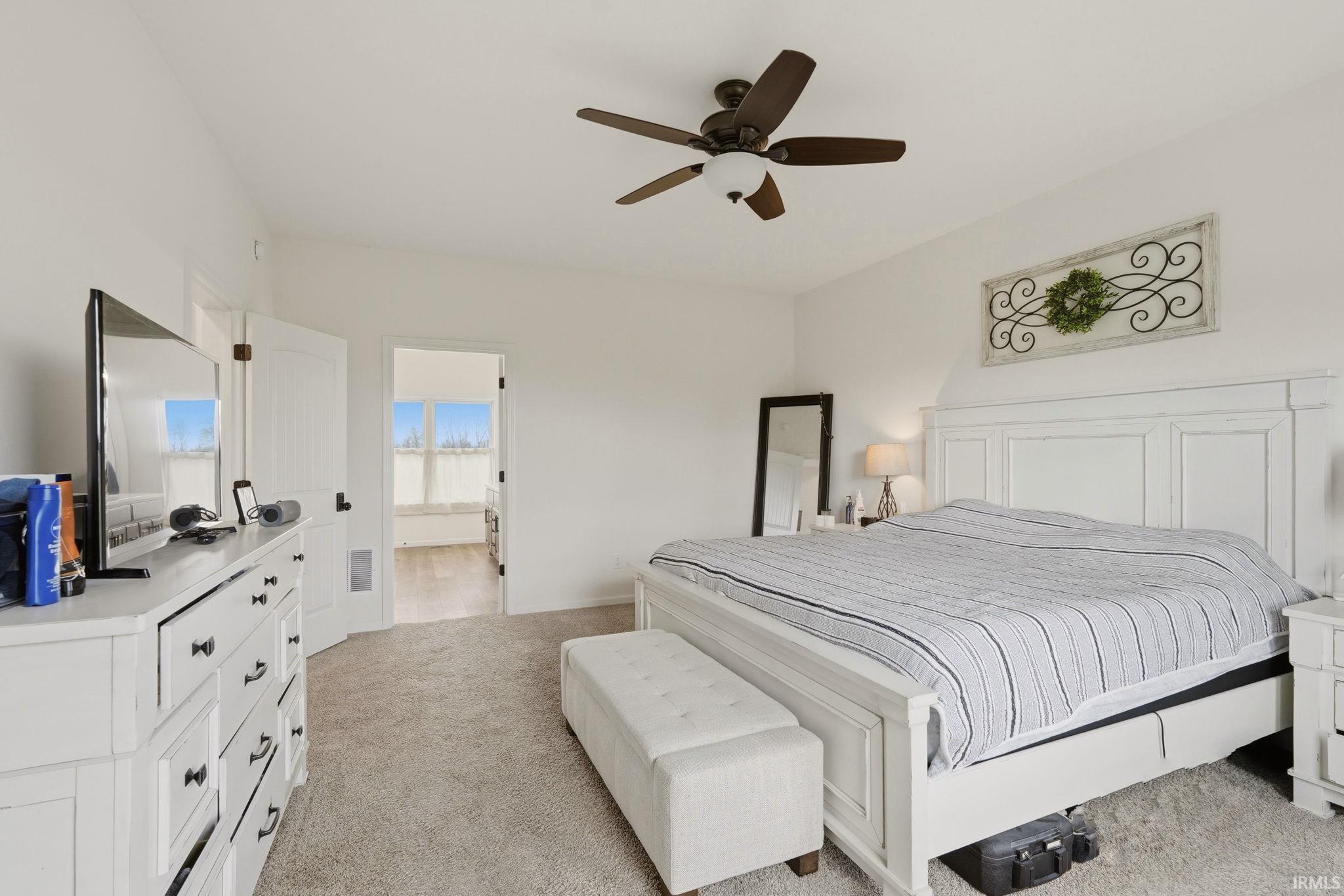 Bedroom featuring light colored carpet and ceiling fan