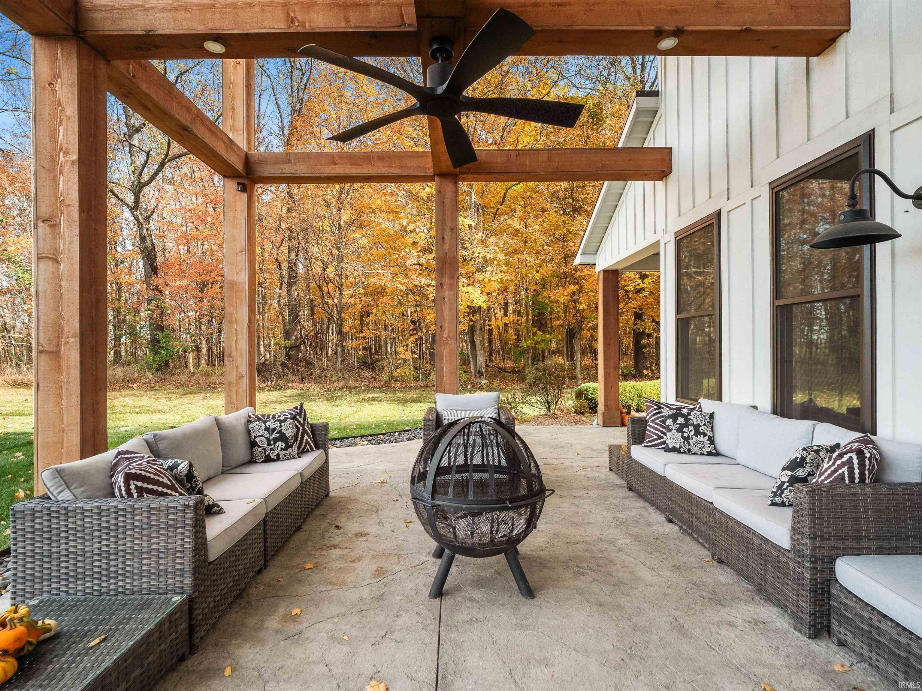 View of patio / terrace featuring an outdoor living space with a fire pit and a ceiling fan