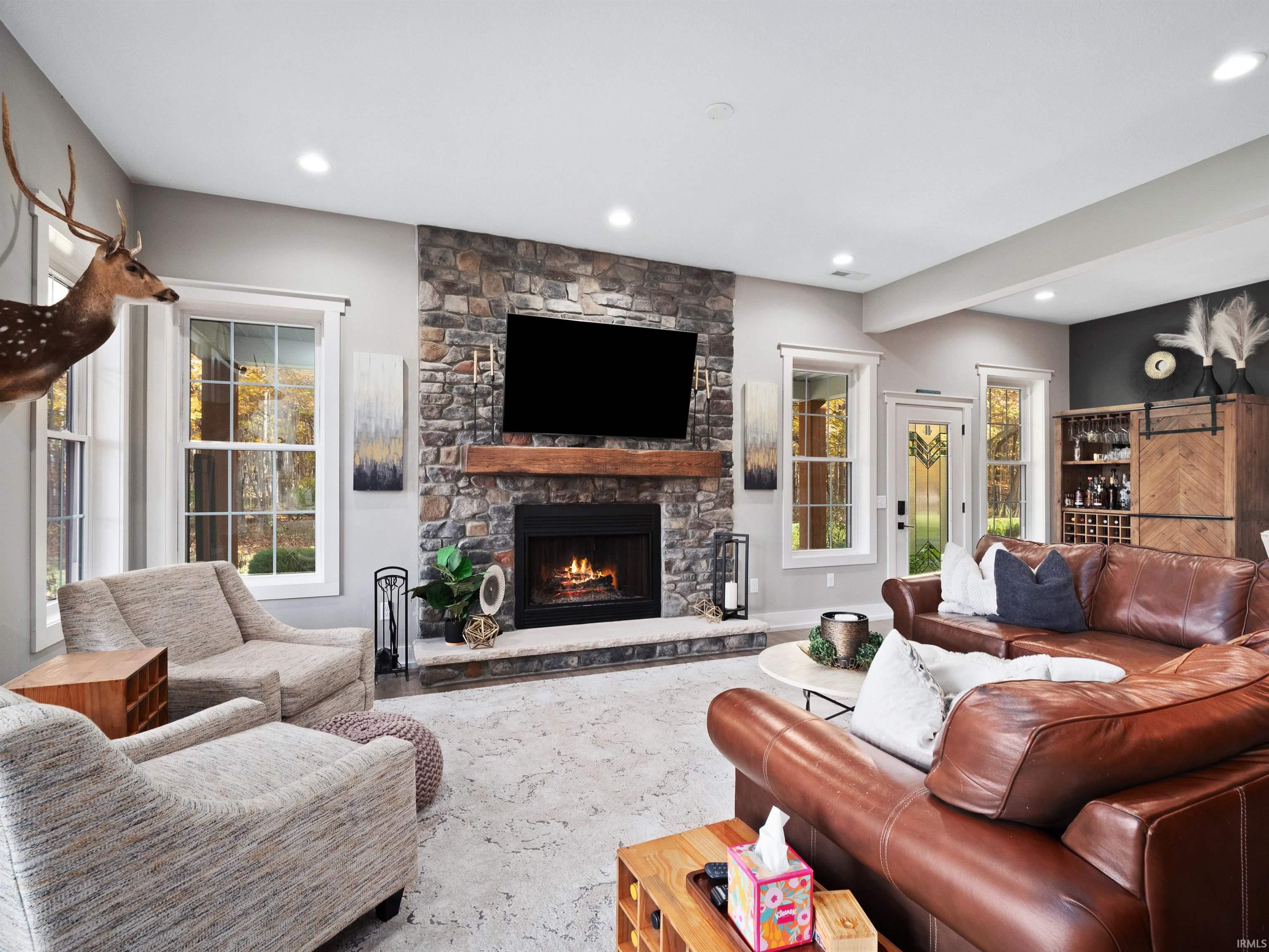Living room with a fireplace and recessed lighting