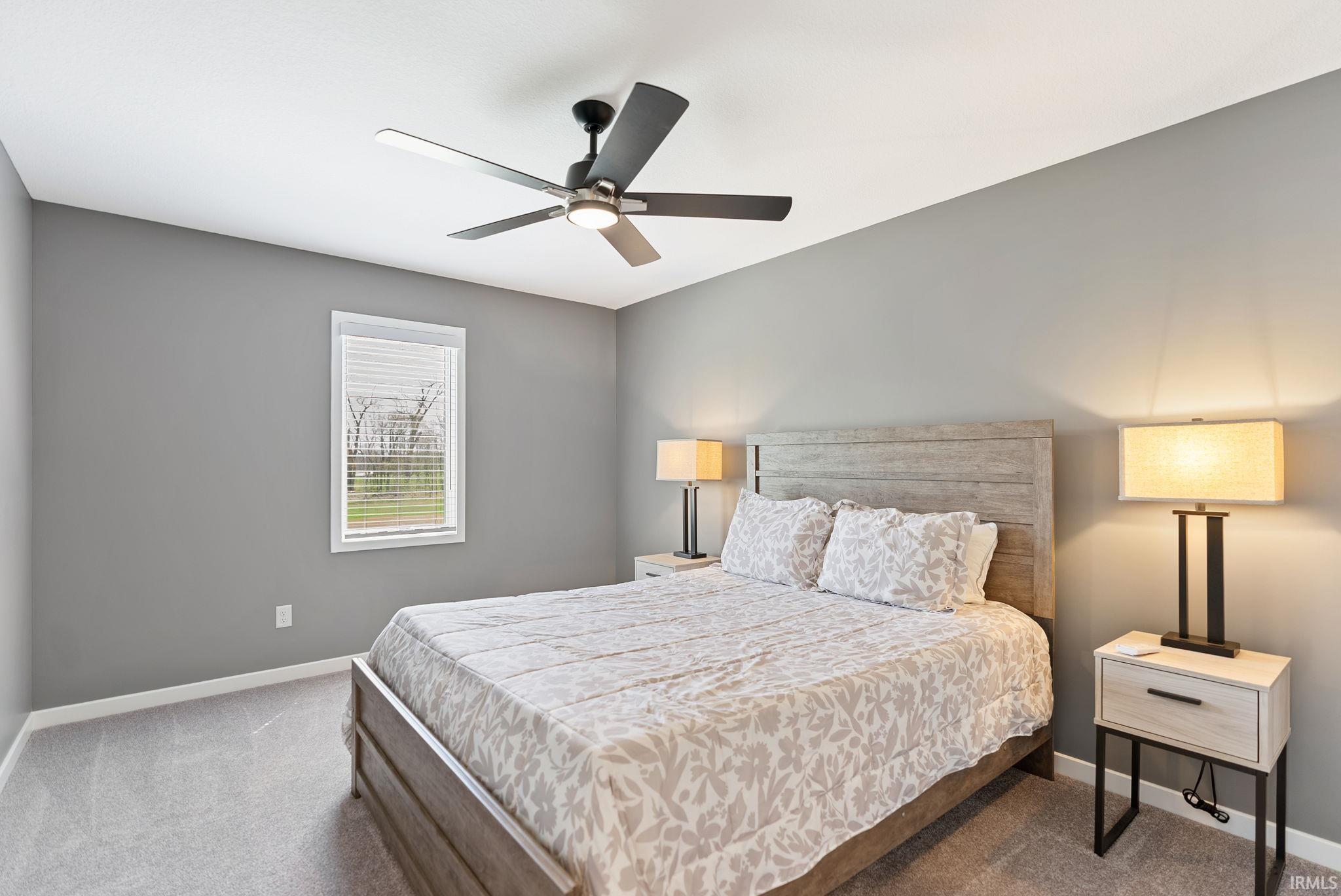 Bedroom featuring a ceiling fan and carpet floors