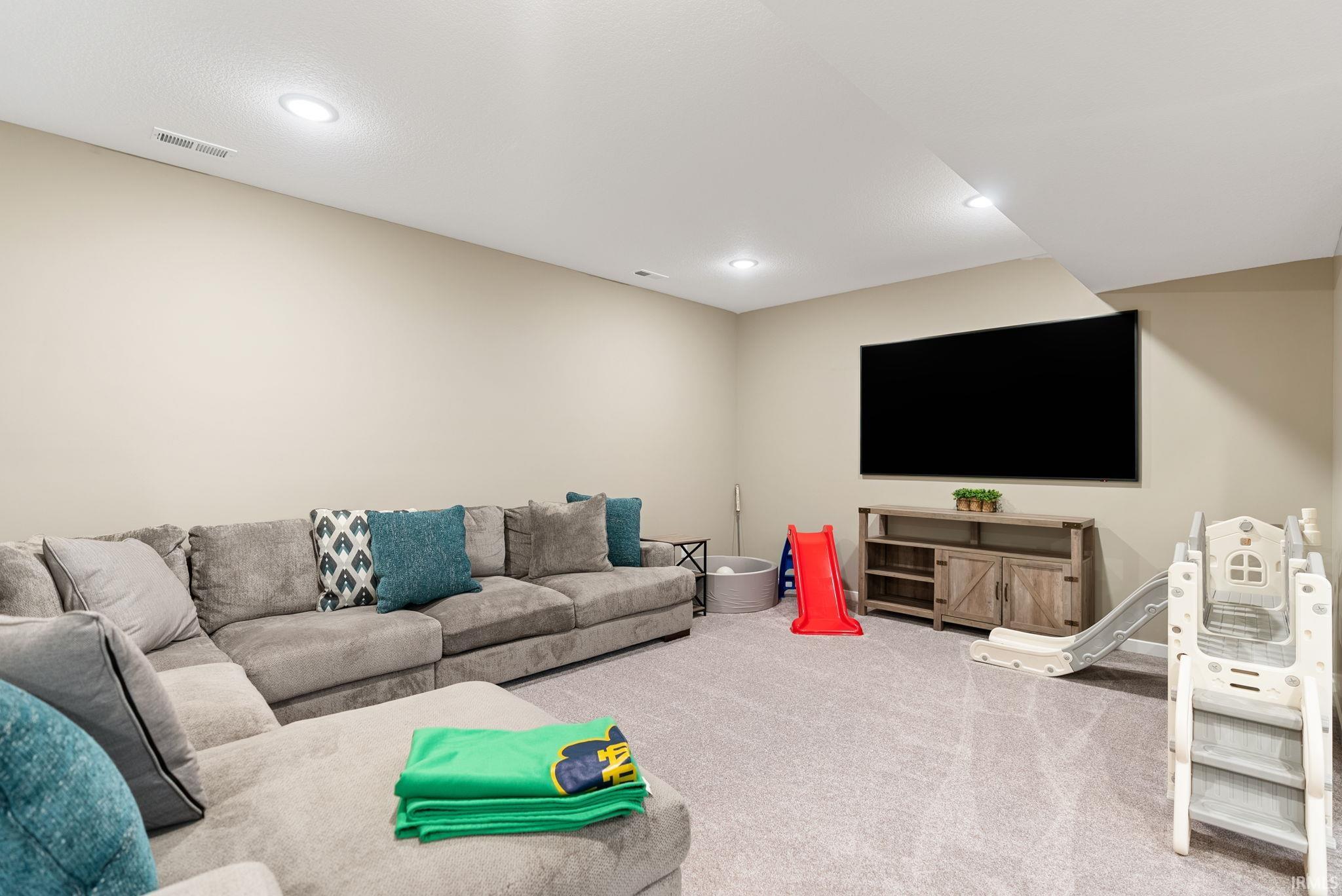 Living room featuring carpet and recessed lighting