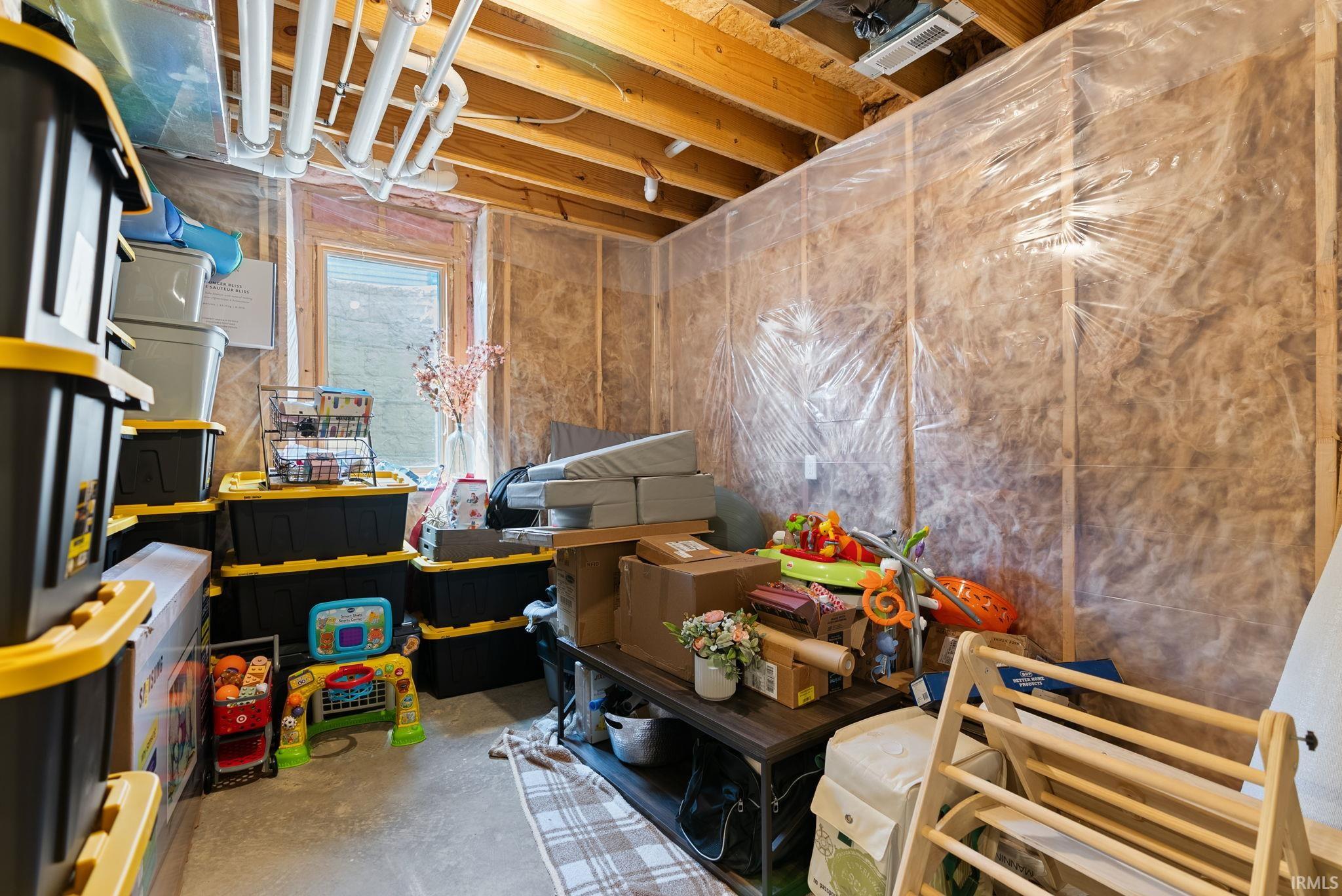Miscellaneous room with unfinished concrete floors