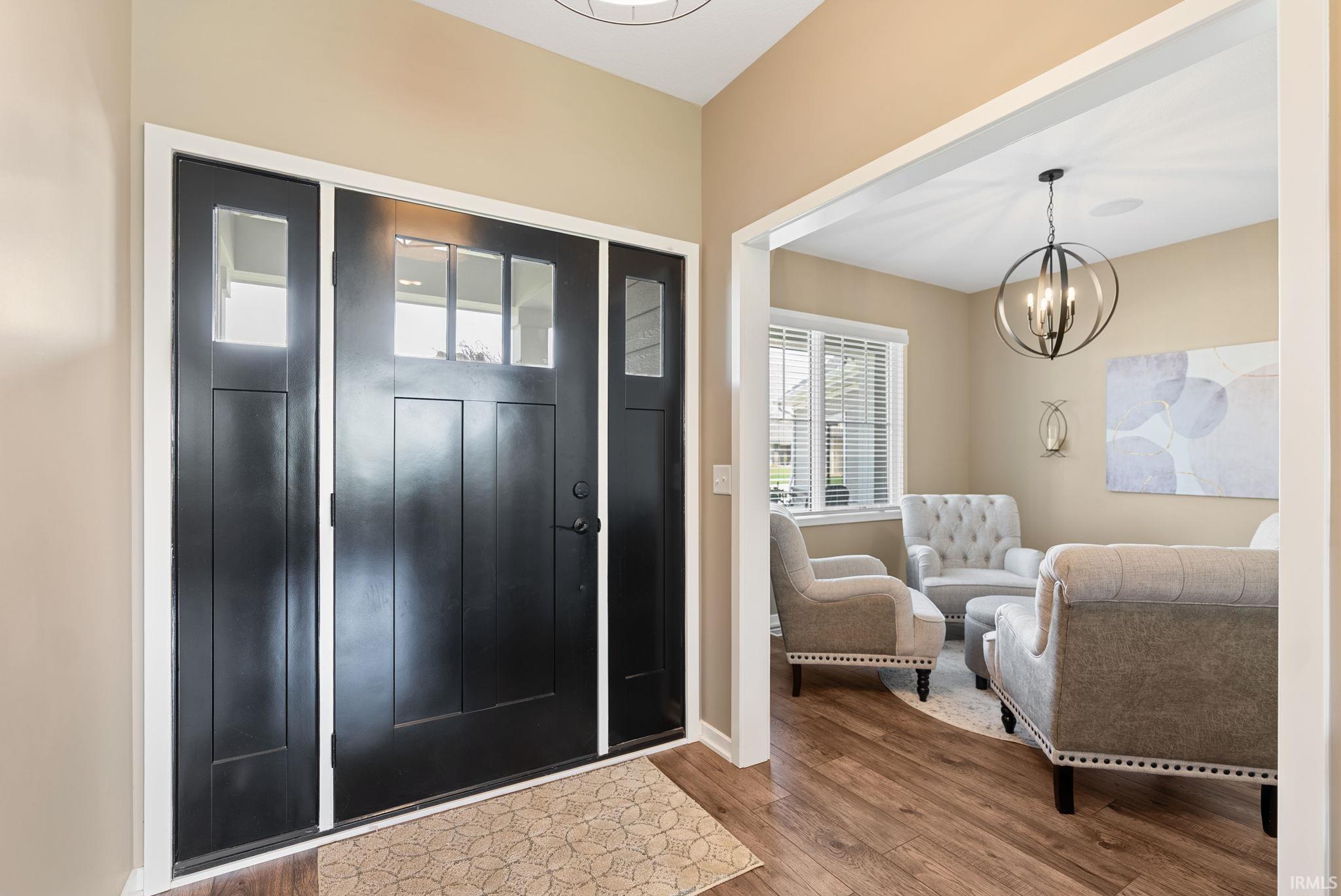 Foyer featuring hanging lights and hardwood / wood-style flooring