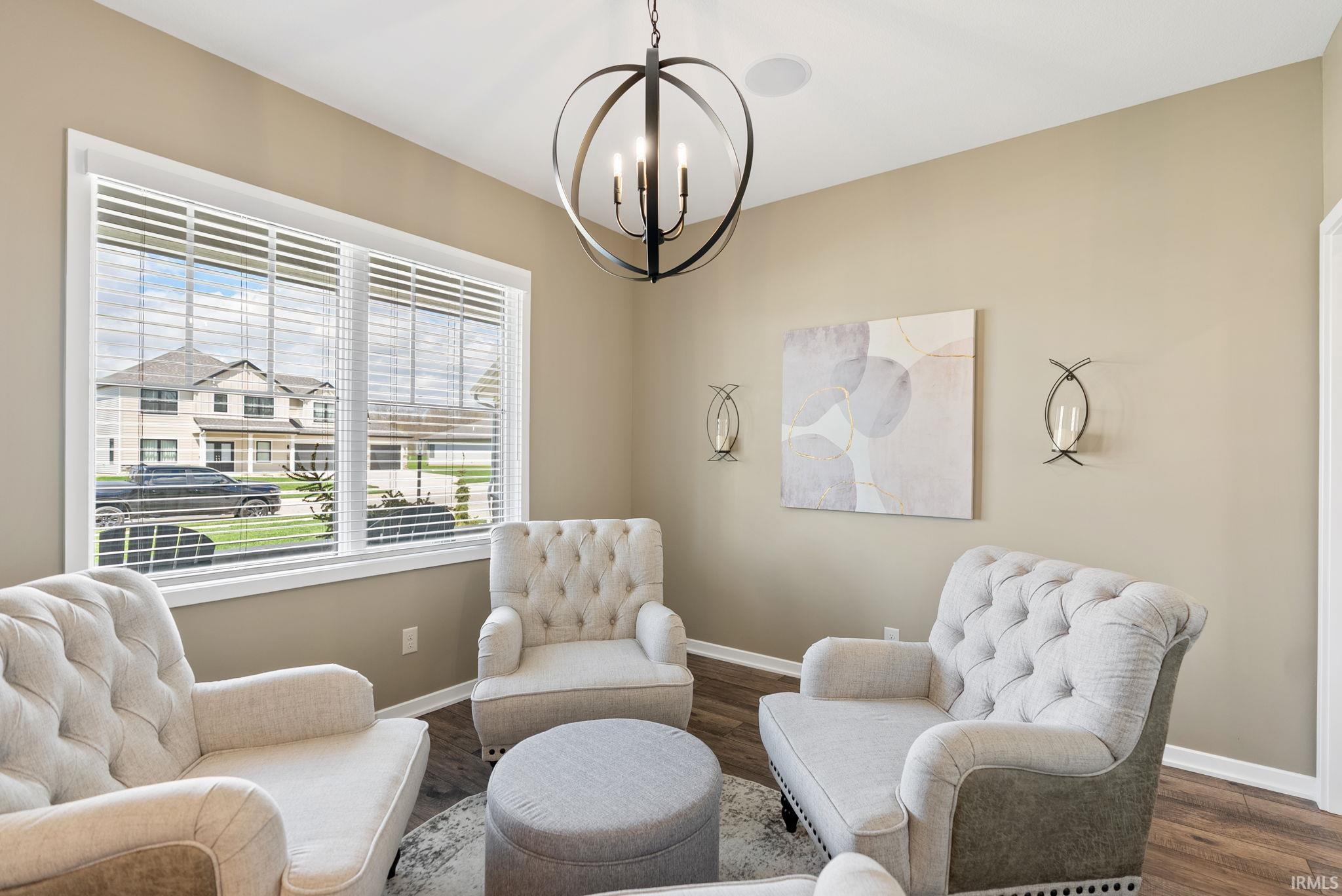 Sitting room with wood finished floors and hanging lights