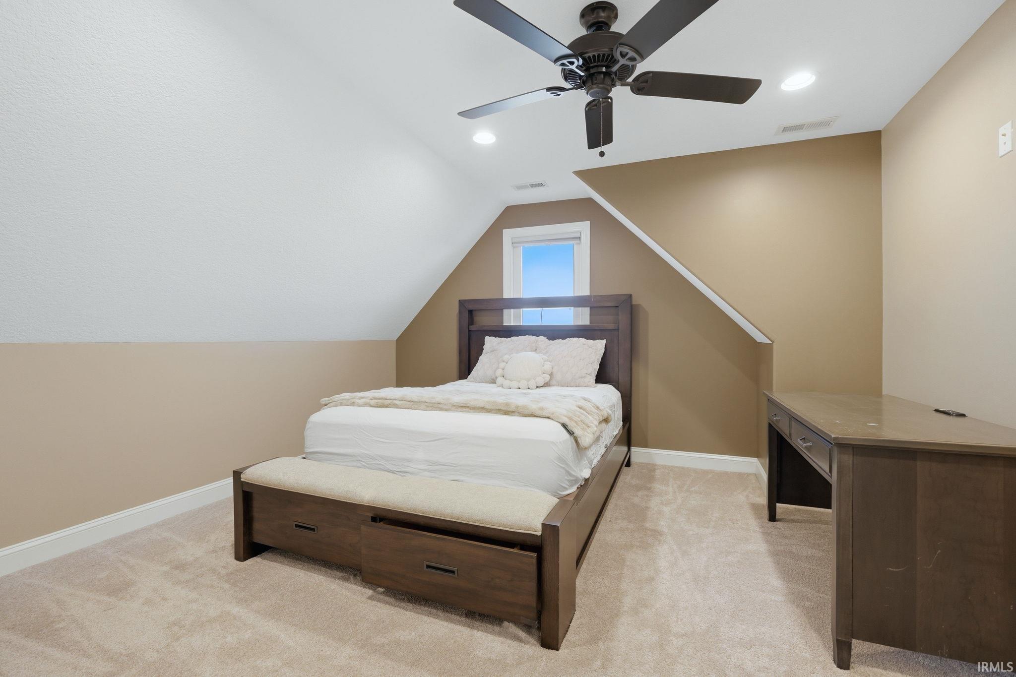 Bedroom with recessed lighting, light colored carpet, a ceiling fan, and vaulted ceiling