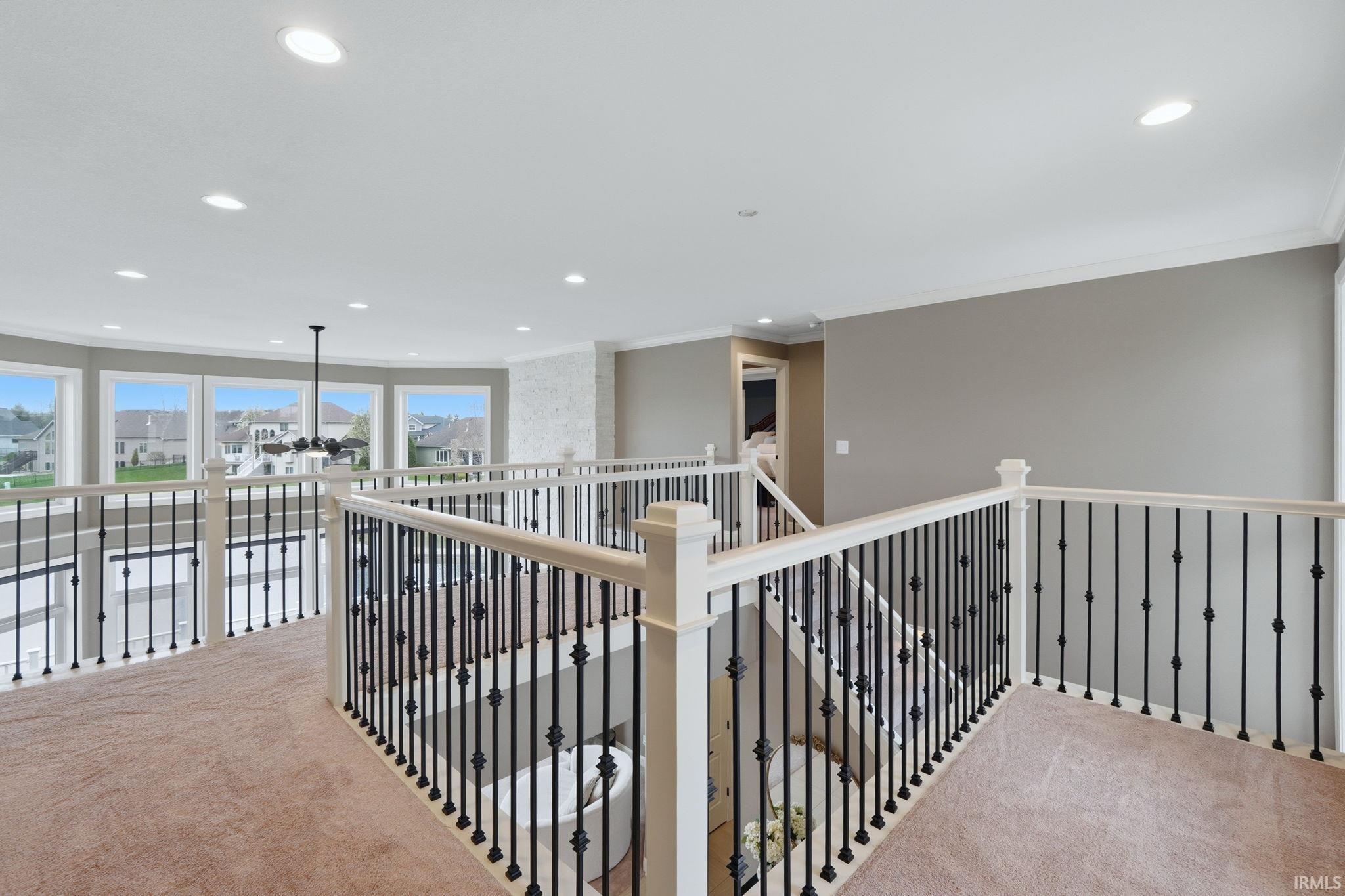 Corridor with carpet, crown molding, and recessed lighting