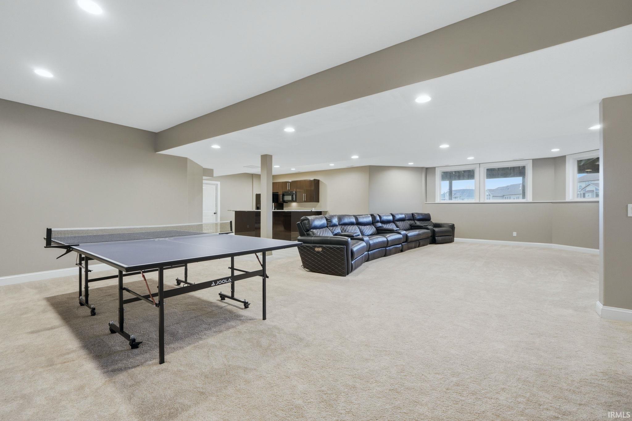 Rec room with light carpet and recessed lighting