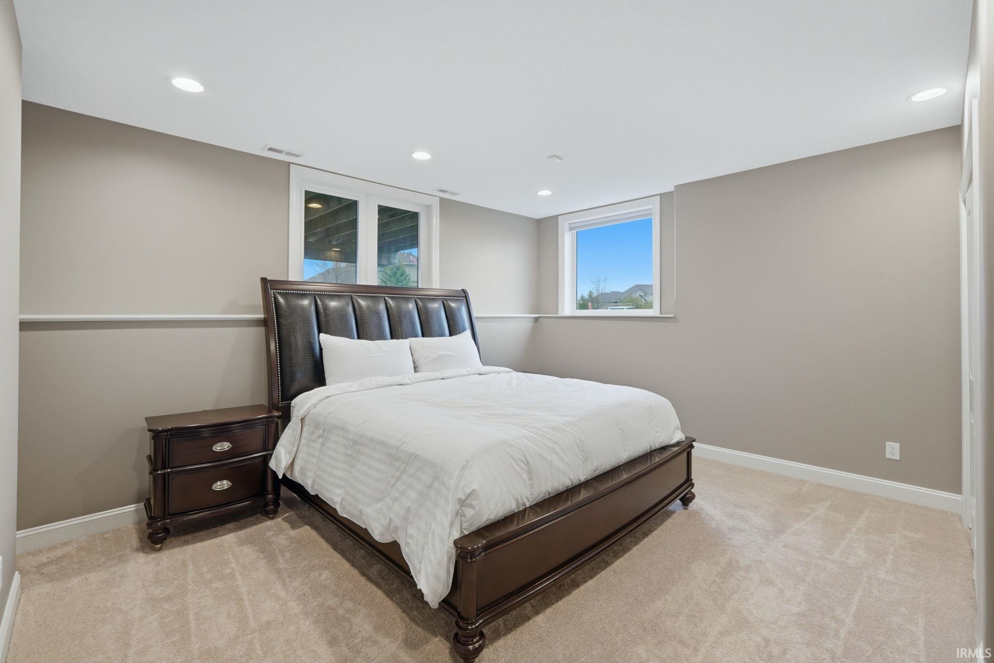 Bedroom featuring light carpet and recessed lighting