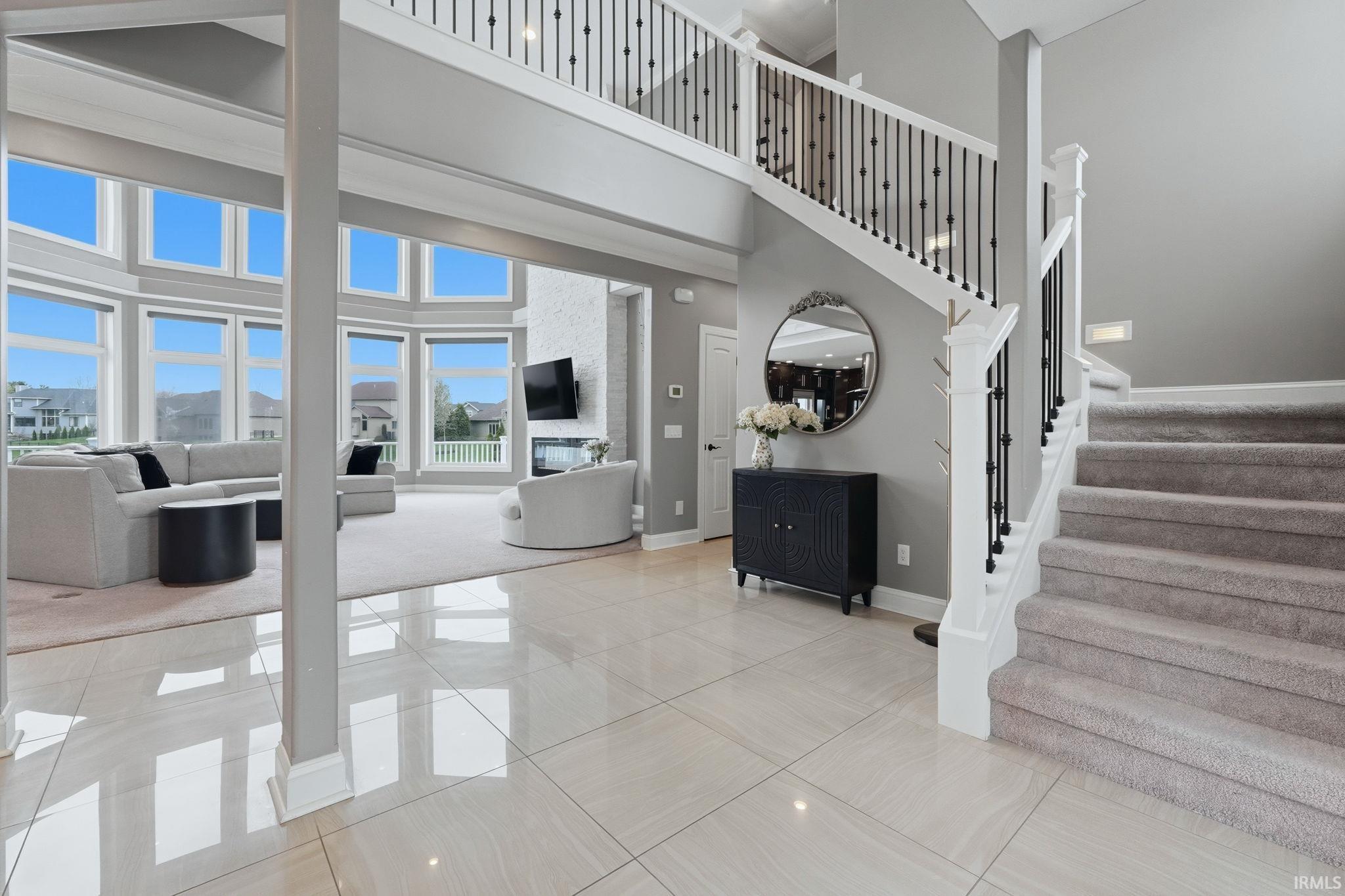 Stairway with a high ceiling and tile patterned floors