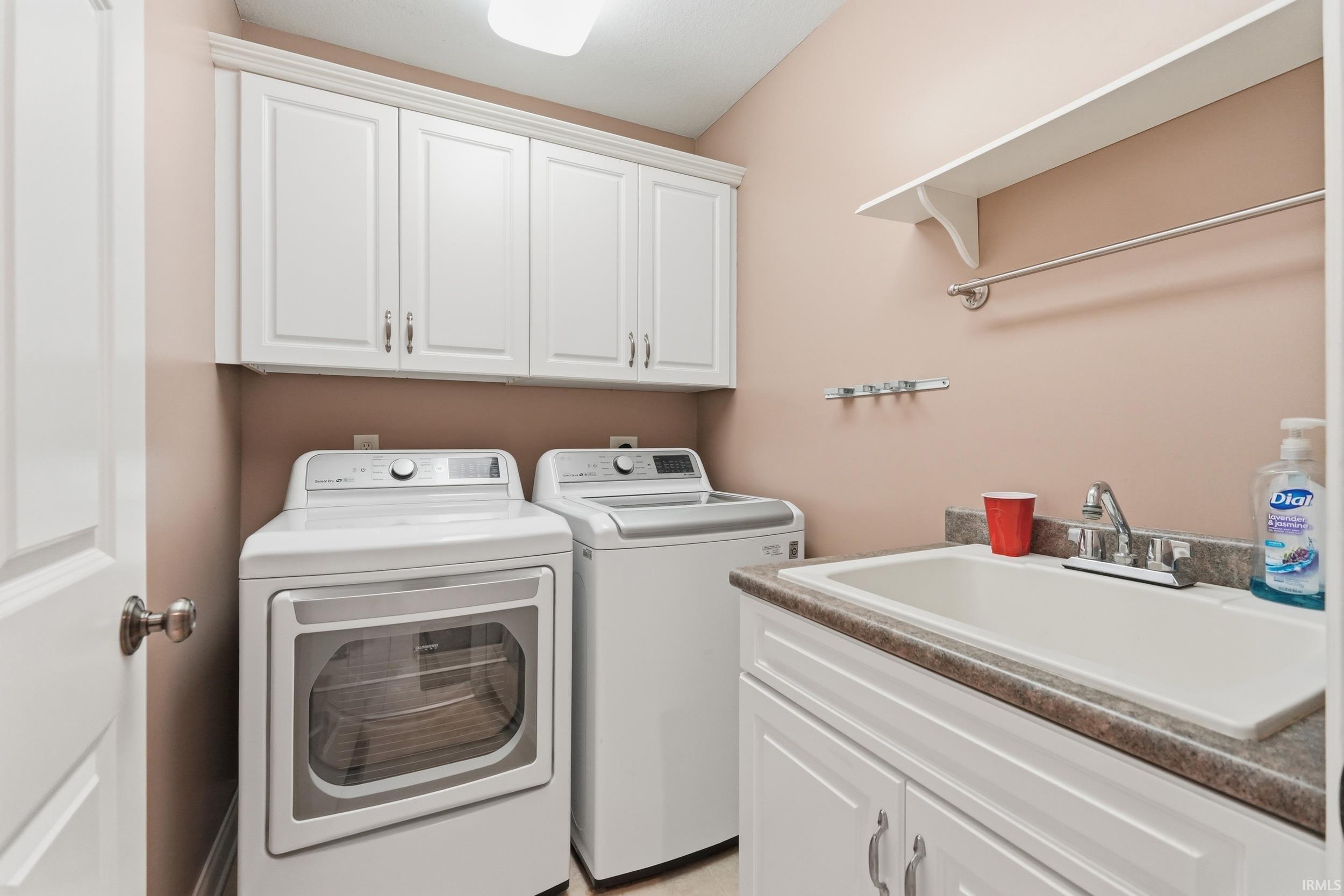 Laundry area with cabinet space and washing machine and dryer