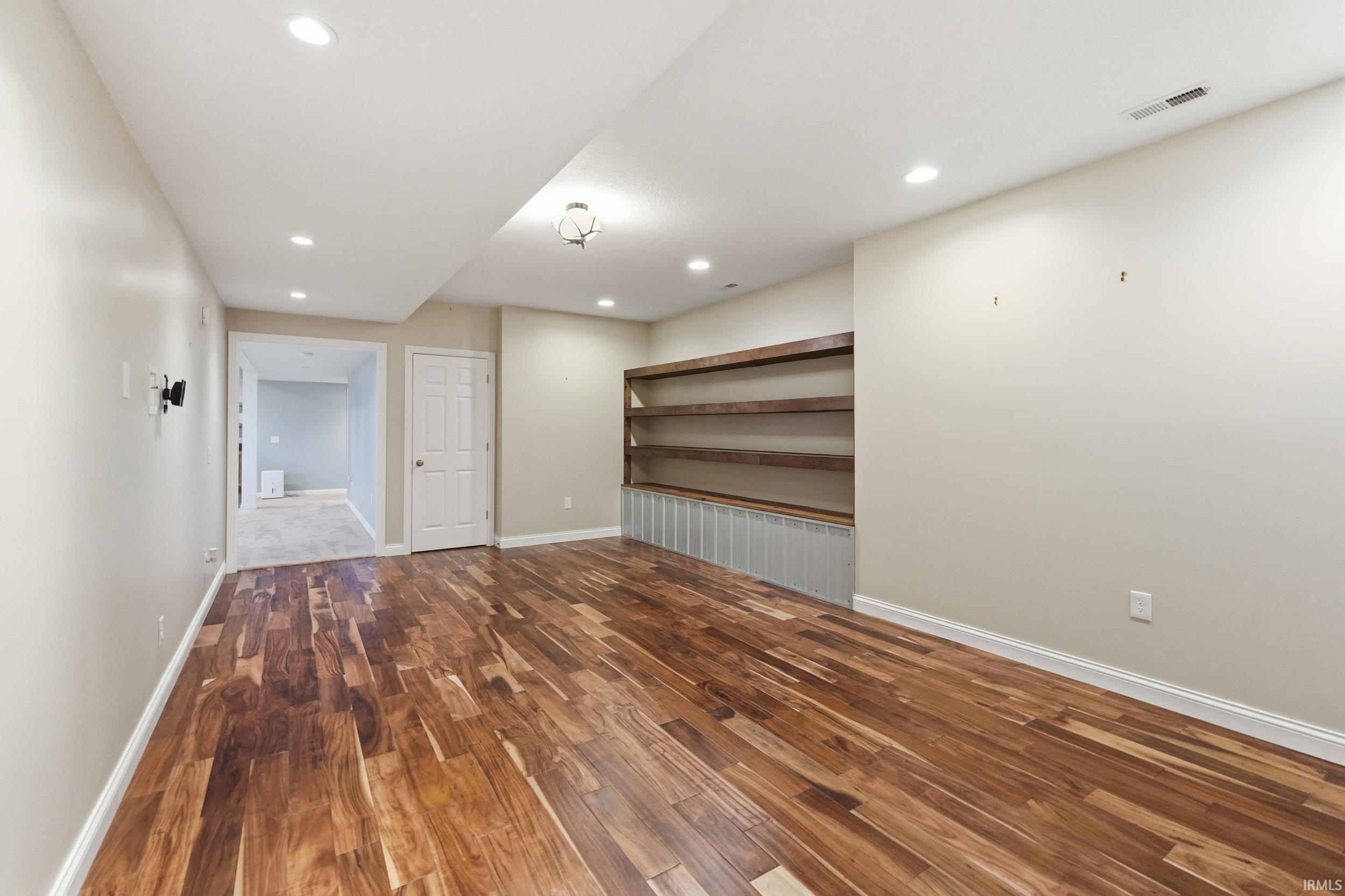 Unfurnished room featuring dark wood-style floors and recessed lighting