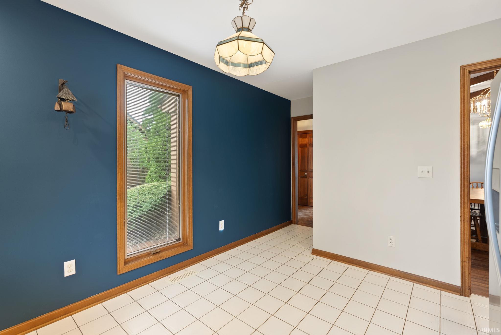 Unfurnished room with baseboards and light tile patterned floors