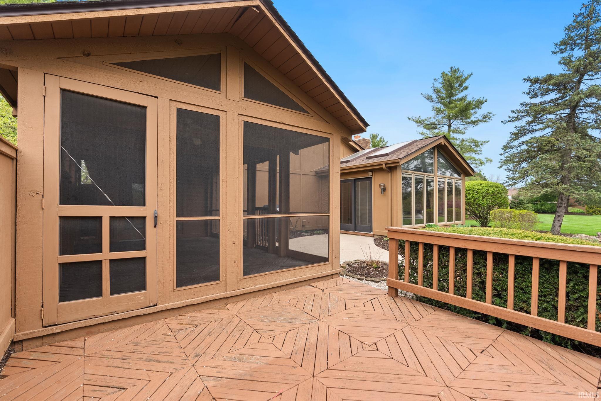 Wooden deck with a sunroom