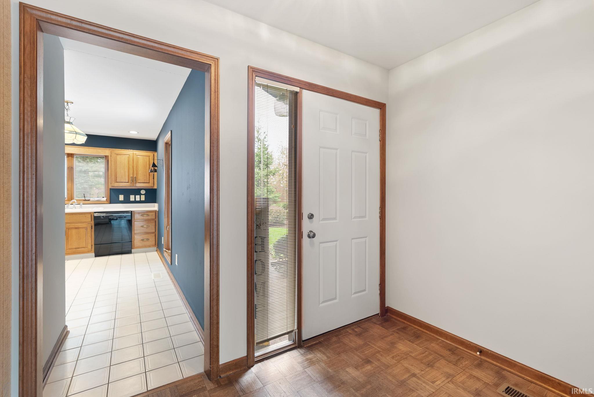 Entrance foyer featuring baseboards and parquet floors
