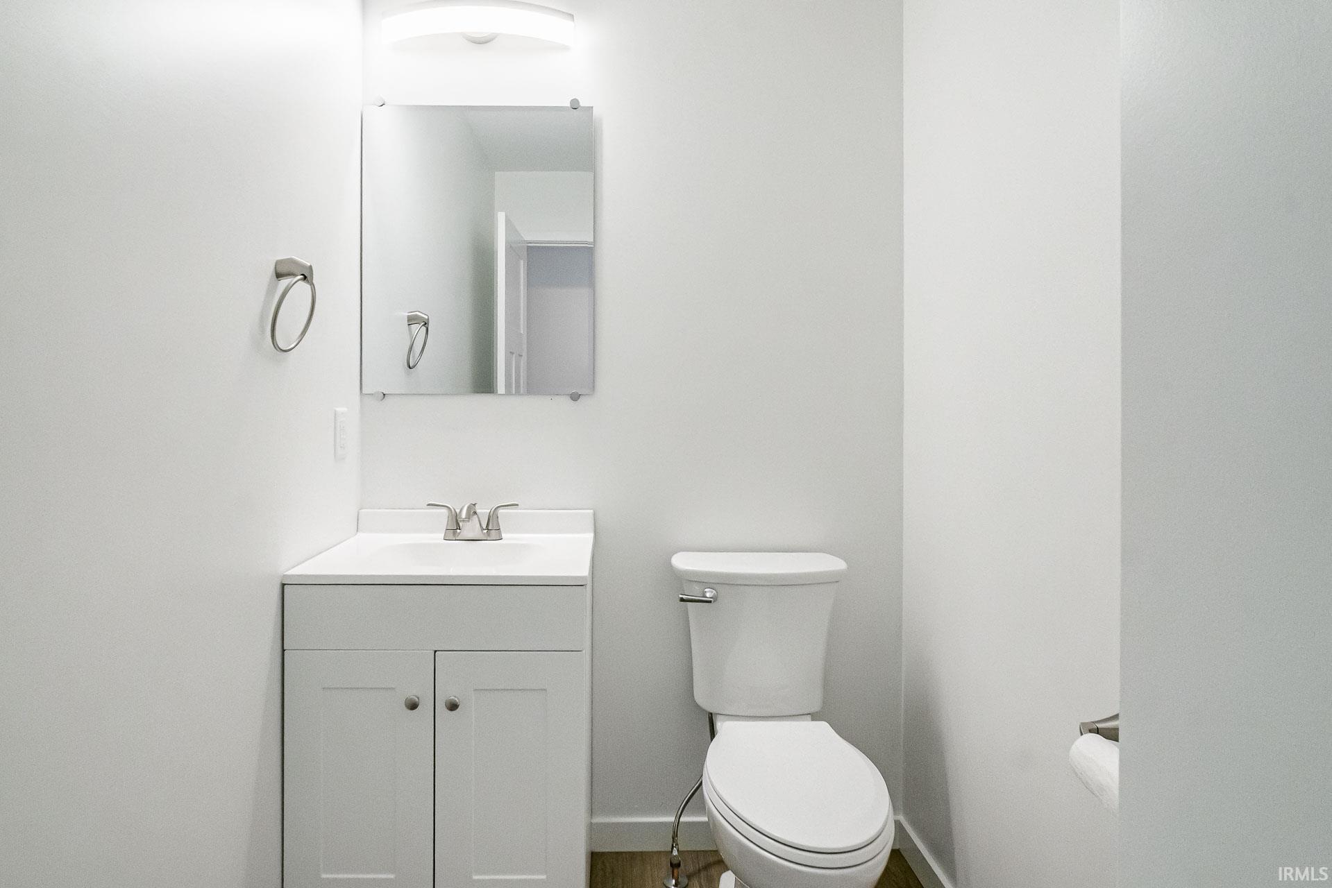 Half bathroom featuring toilet and vanity