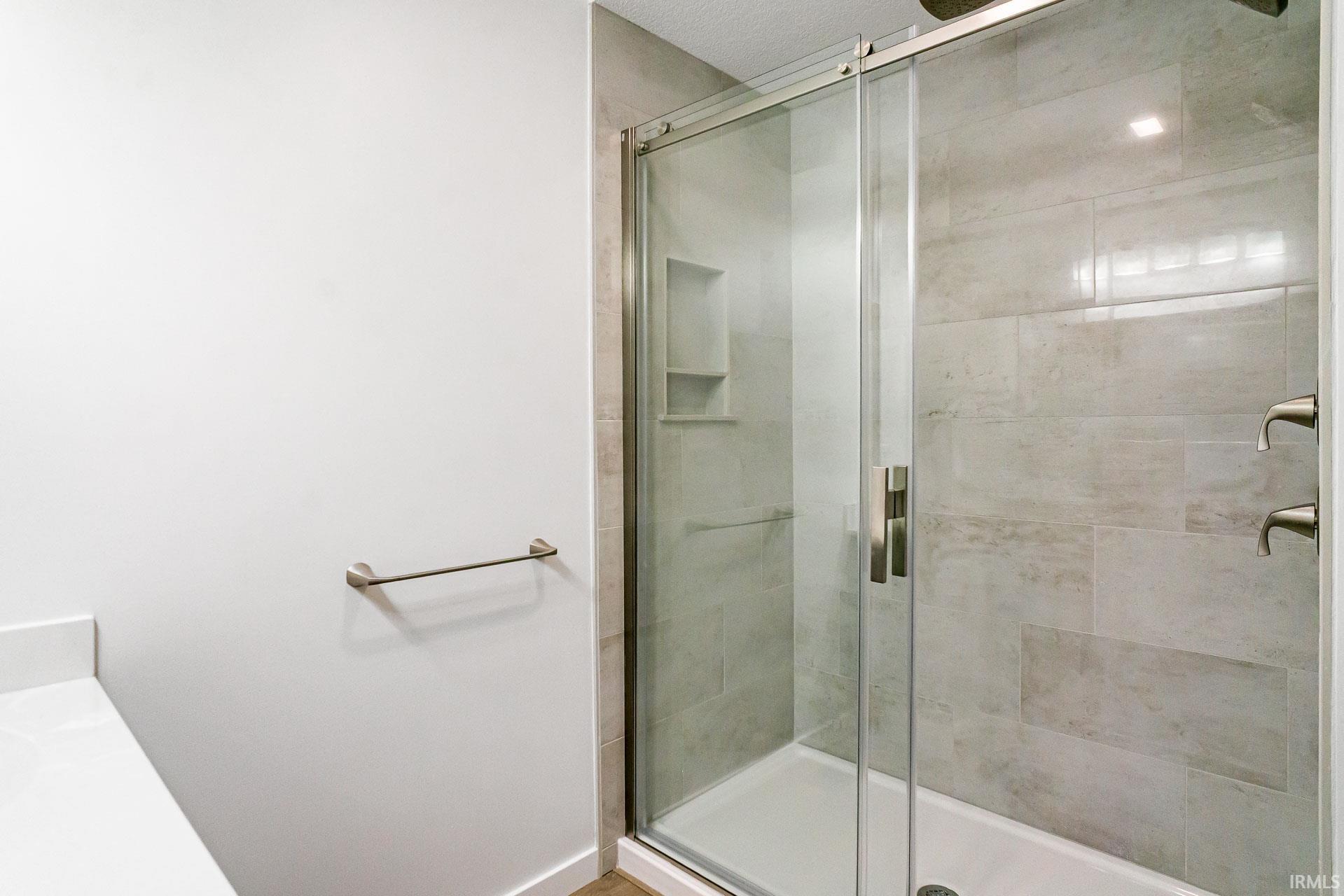 Bathroom featuring a shower stall and vanity
