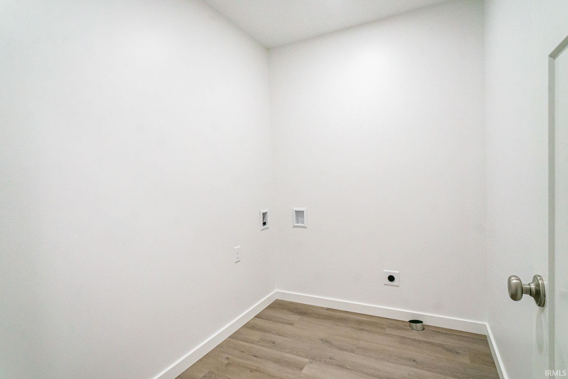 Laundry room featuring washer hookup, light wood finished floors, and hookup for an electric dryer