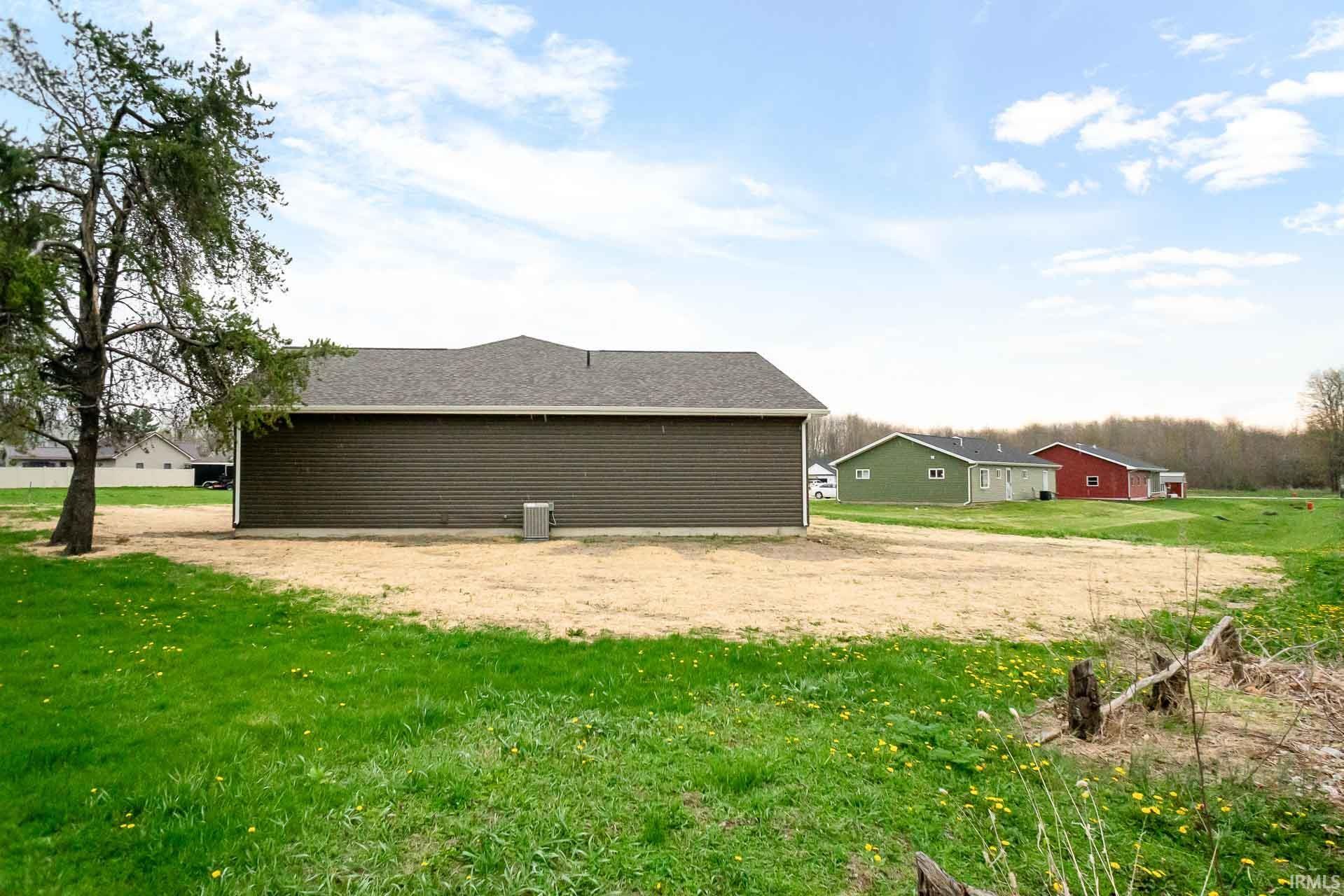 View of property exterior featuring a lawn