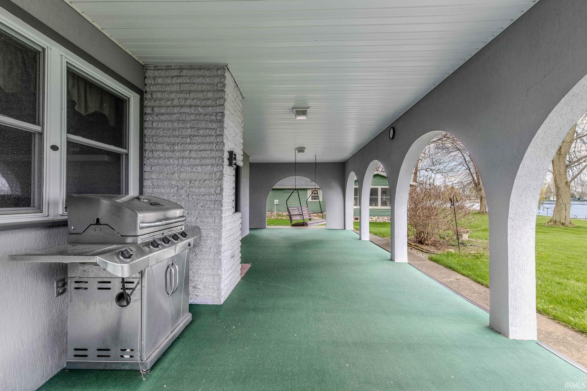View of patio with a grill