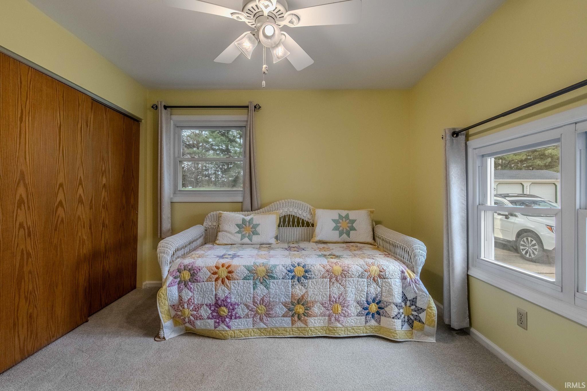 Bedroom featuring carpet floors, a closet, and ceiling fan