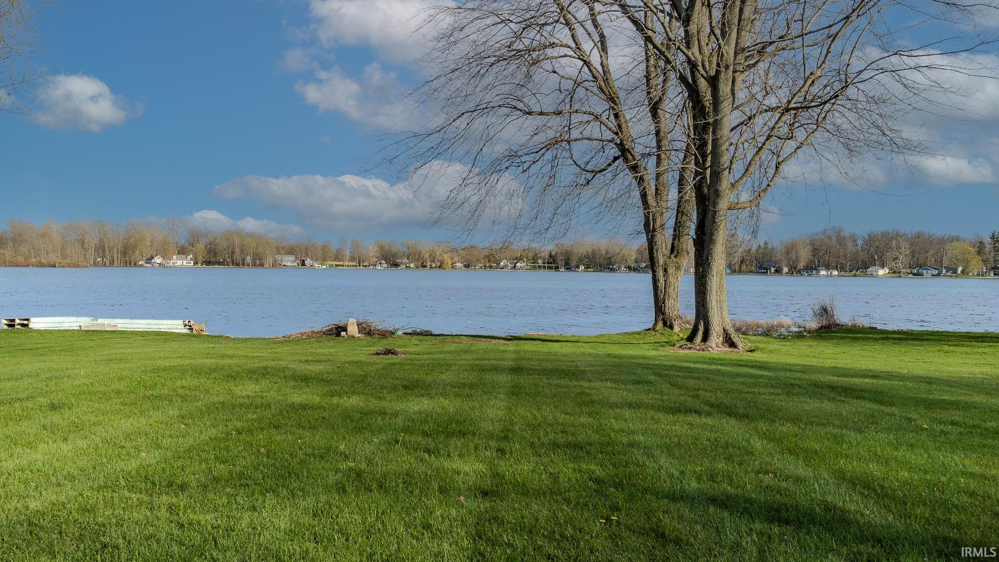 View of green lawn featuring a water view