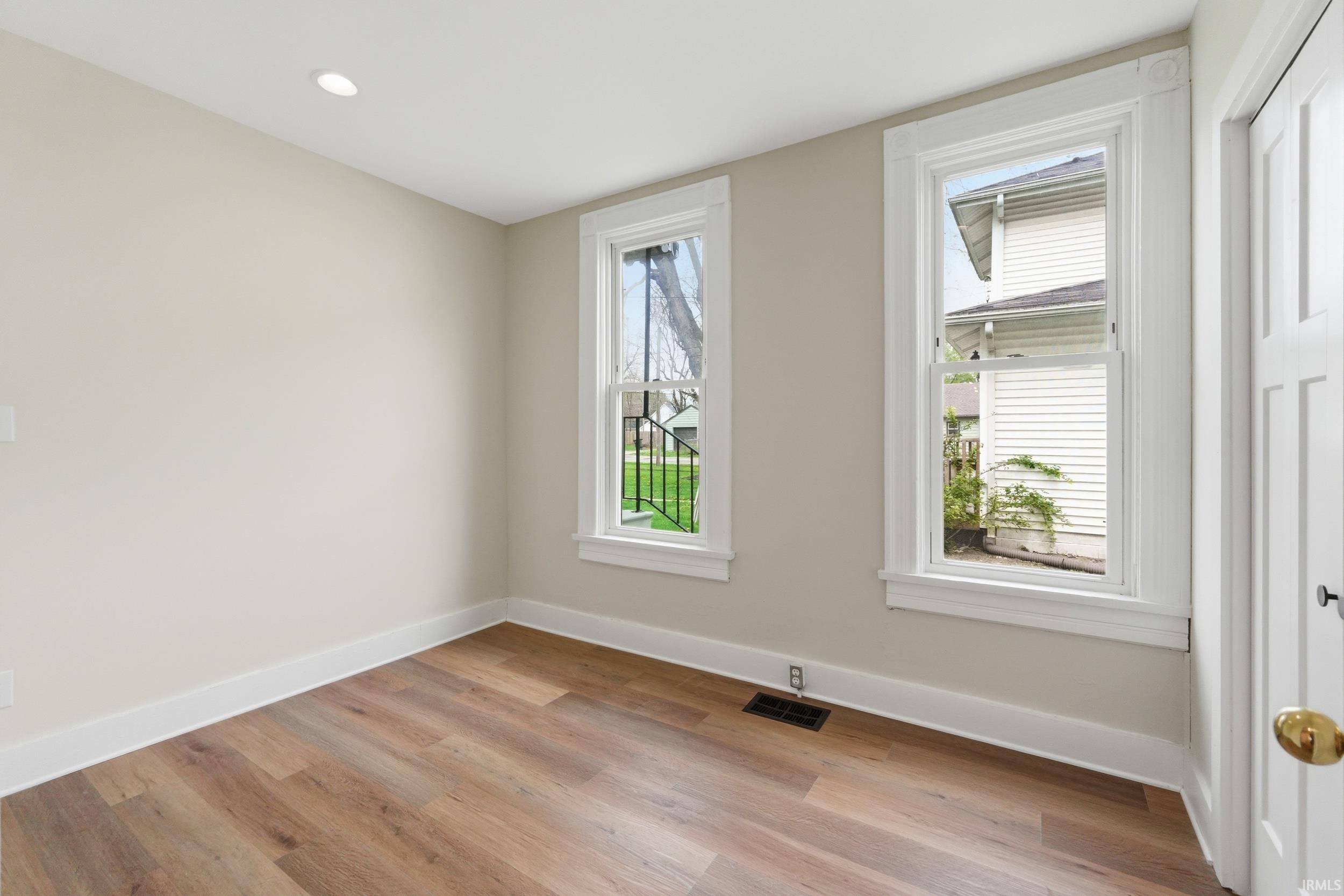 Spare room with light wood-style floors and recessed lighting