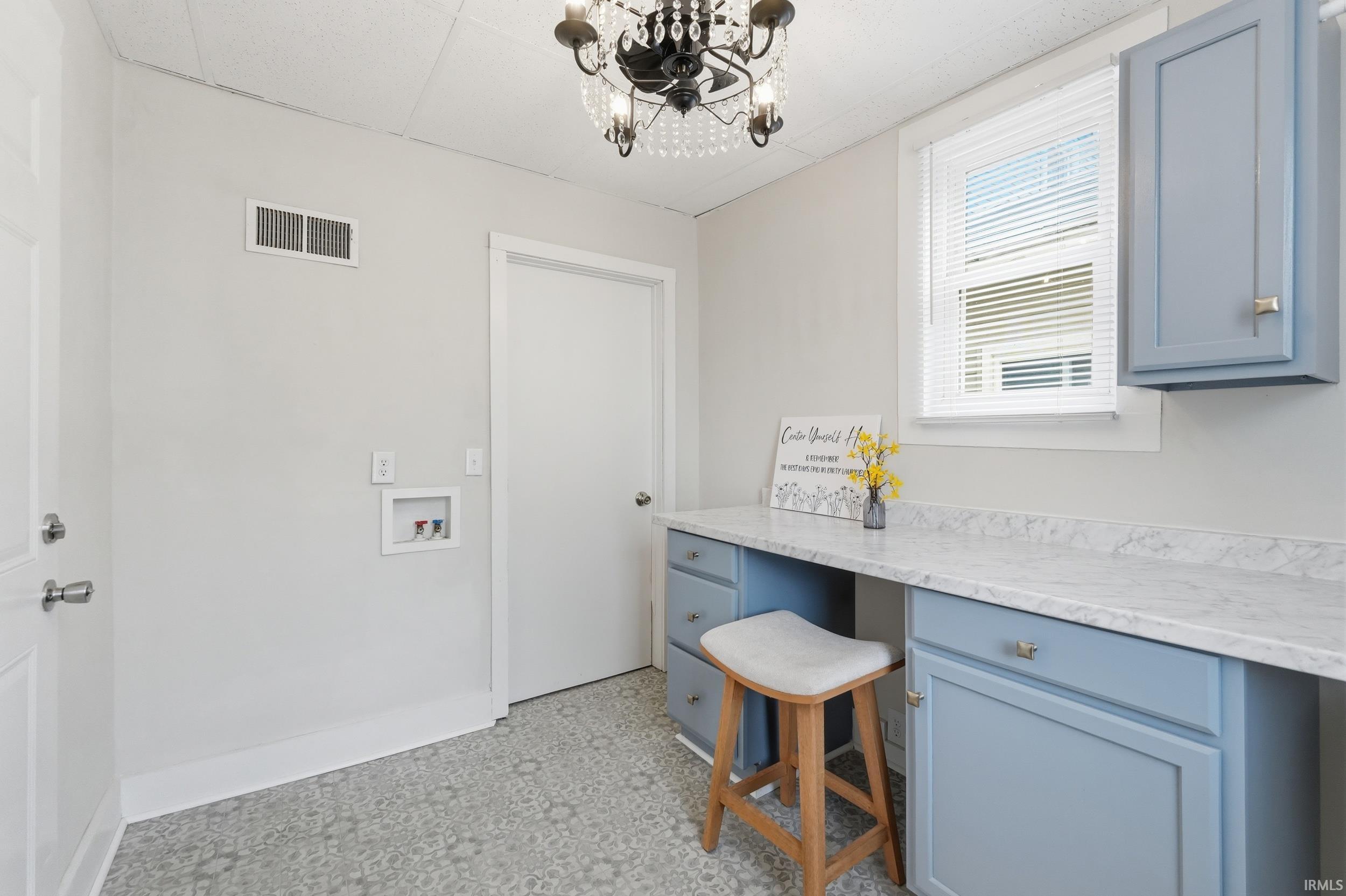 Laundry room featuring hanging lights and washer hookup