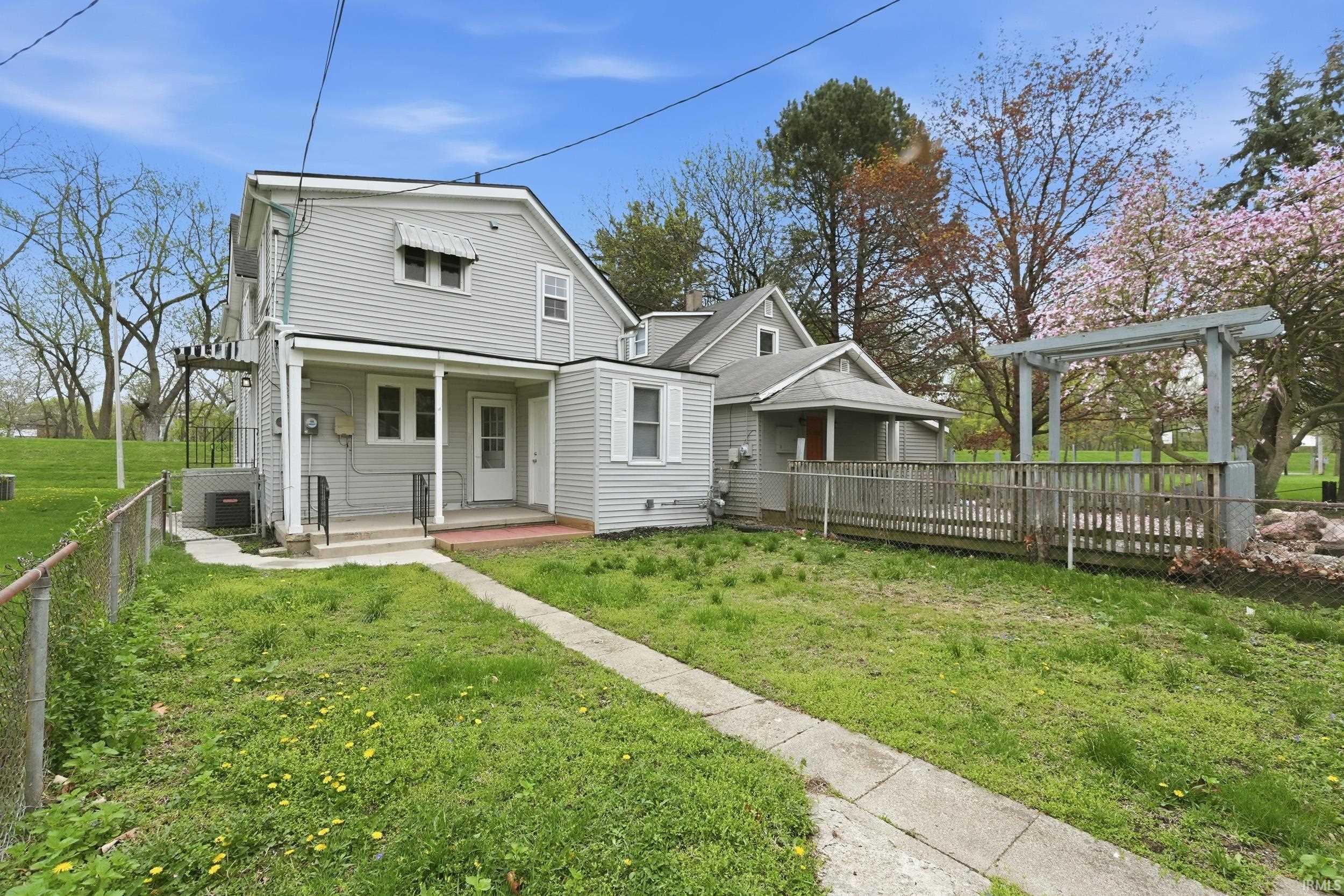 Back of property featuring covered porch